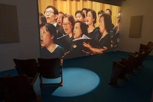 5 'throw your arms around the world': samson young and the M+ effect: Chloé Wolifson, hong kong Samson Young, We are the World , as performed by the Hong Kong Federation of Trade Unions Choir , 2017, installation view, ‘Songs for Disaster Relief World Tour’, M+ Pavilion, West Kowloon, 2018; image courtesy the artist
