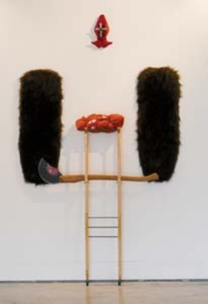 11 The Repression of the Irrepressible: Mona Ryder’s Barcelona Twostep: NOLA FARMAN Mona Ryder, Lost Parcel, 2007, crutches, wheels, MDF and fake fur, wrapped parcel with stamps, shoes, red dyed stockings and metal cross. Courtesy the artist. Photograph by Benjamin Townsend Photography