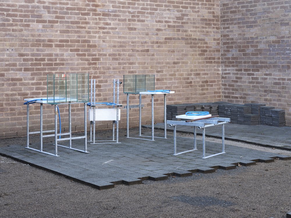  Paul Cullen,  Weather Stations , 2009, installation view, ‘Huarere: Weather Eye, Weather Ear’, Te Tuhi, Tamaki Makaurau/Auckland, 2023; galvanised steel framing and concrete, hosing, pipes and glass vitrines, dimensions variable; courtesy Paul Culle