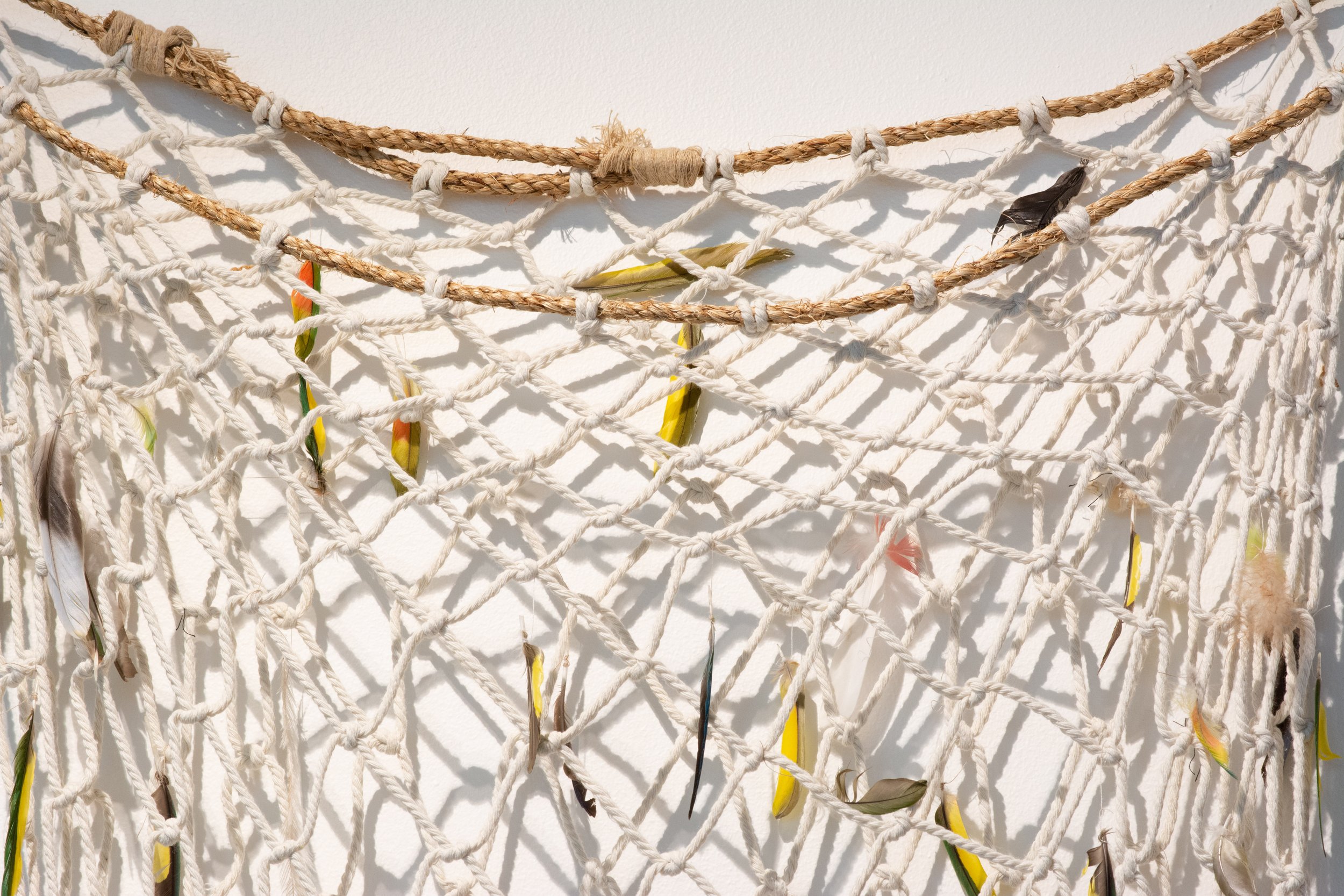 Unbound Collective, Ali Baker and Seana, Skirt nets (detail), 2023, recycled cotton with found feathers and manila rope, variable sizes