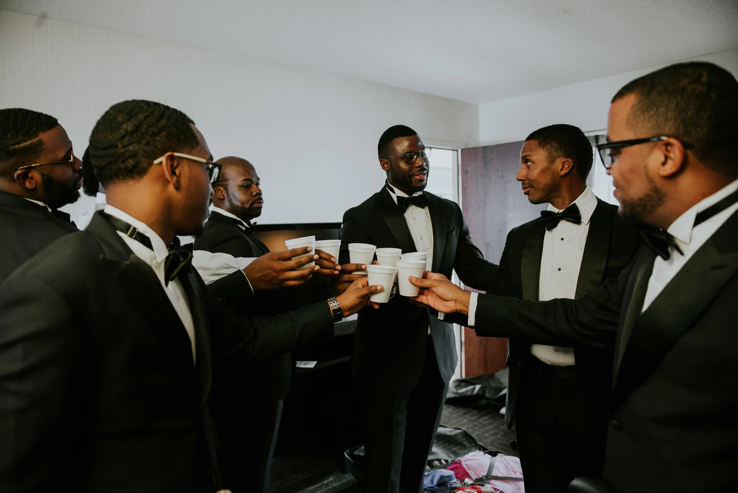 Groomsmen toasting to groom before wedding ceremony