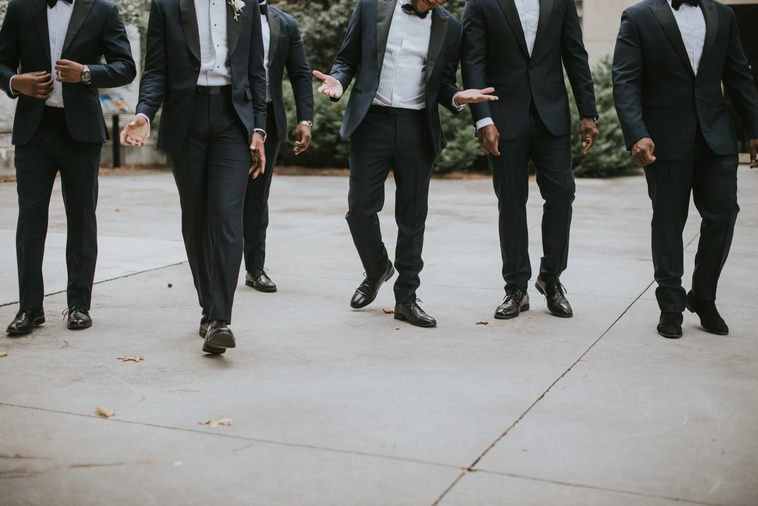 Groomsmen walking in navy Indochino tuxedos