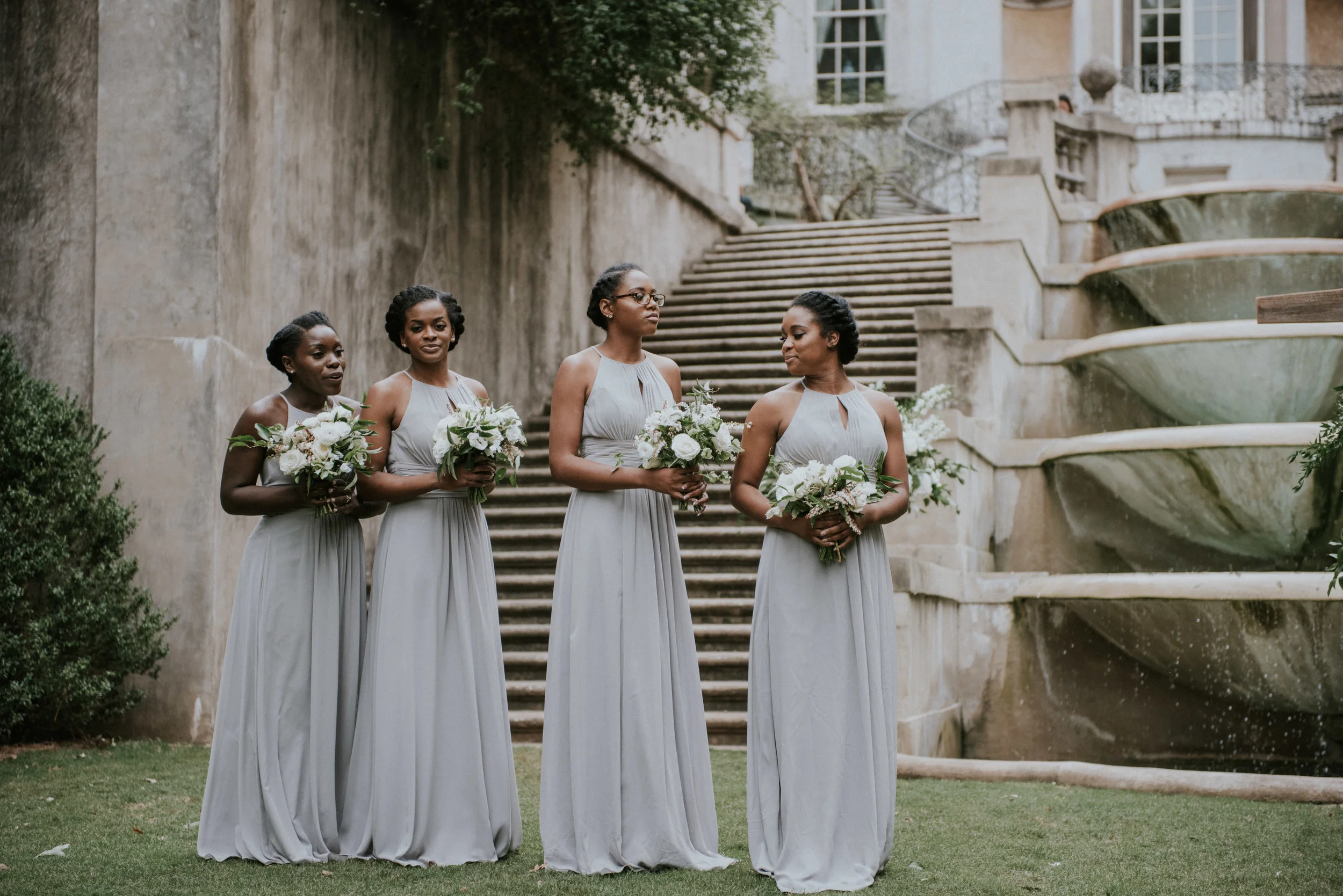Bridesmaids at wedding ceremony on Swan House lawn in Atlanta, GA