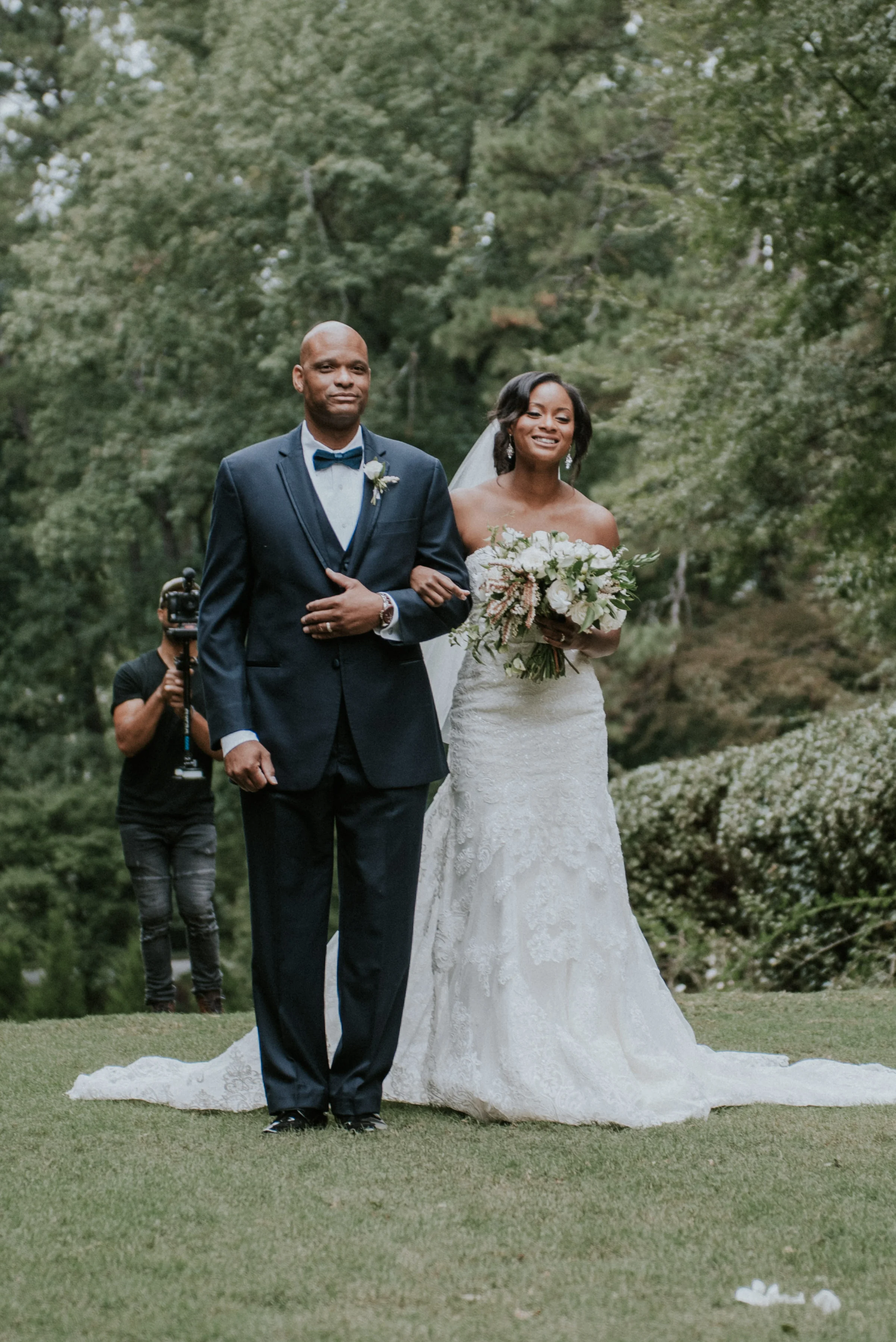 Bride smiling walking down the aisle at Swan House in Atlanta, GA