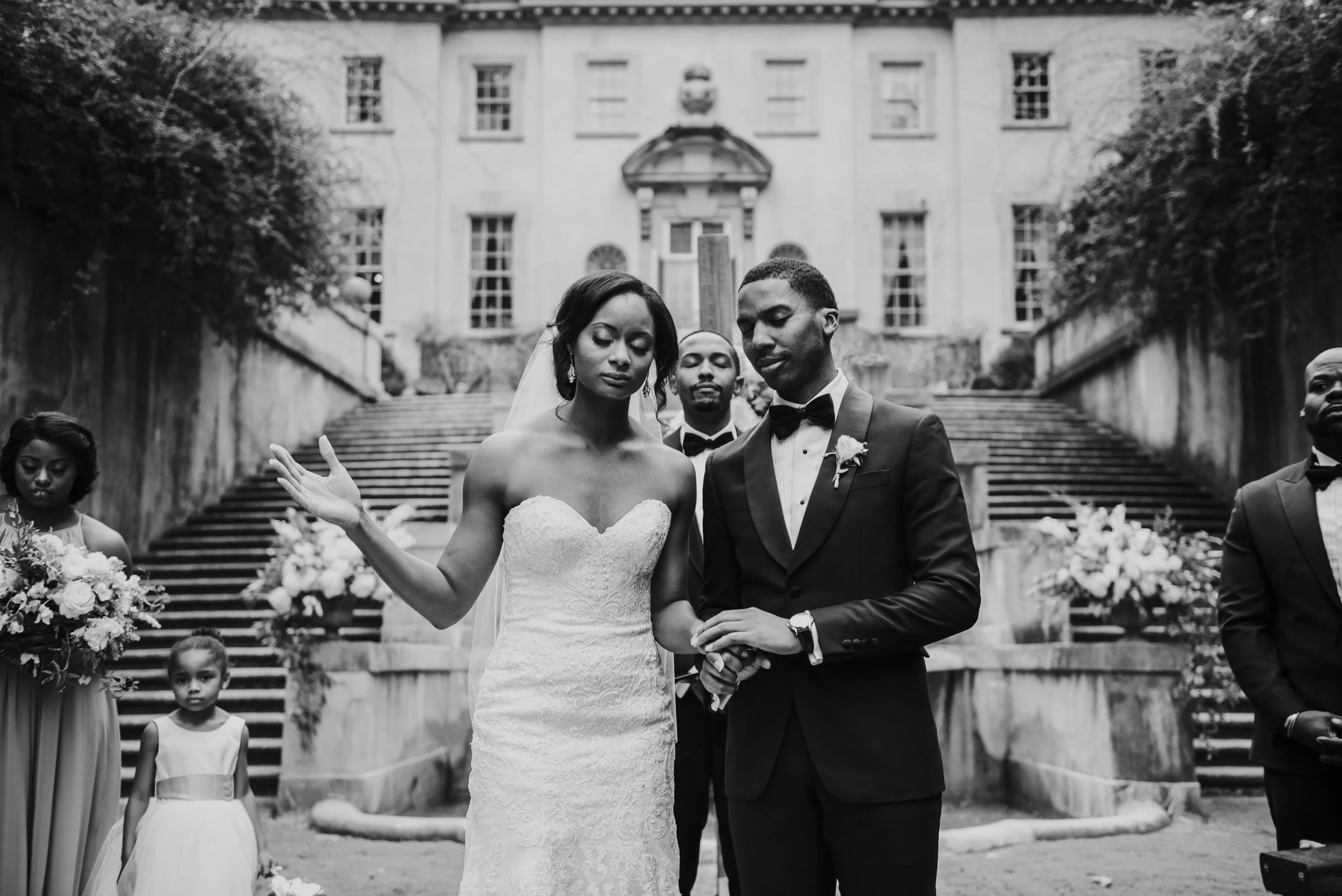 Bride and groom pray at Swan House wedding ceremony in Atlanta, GA