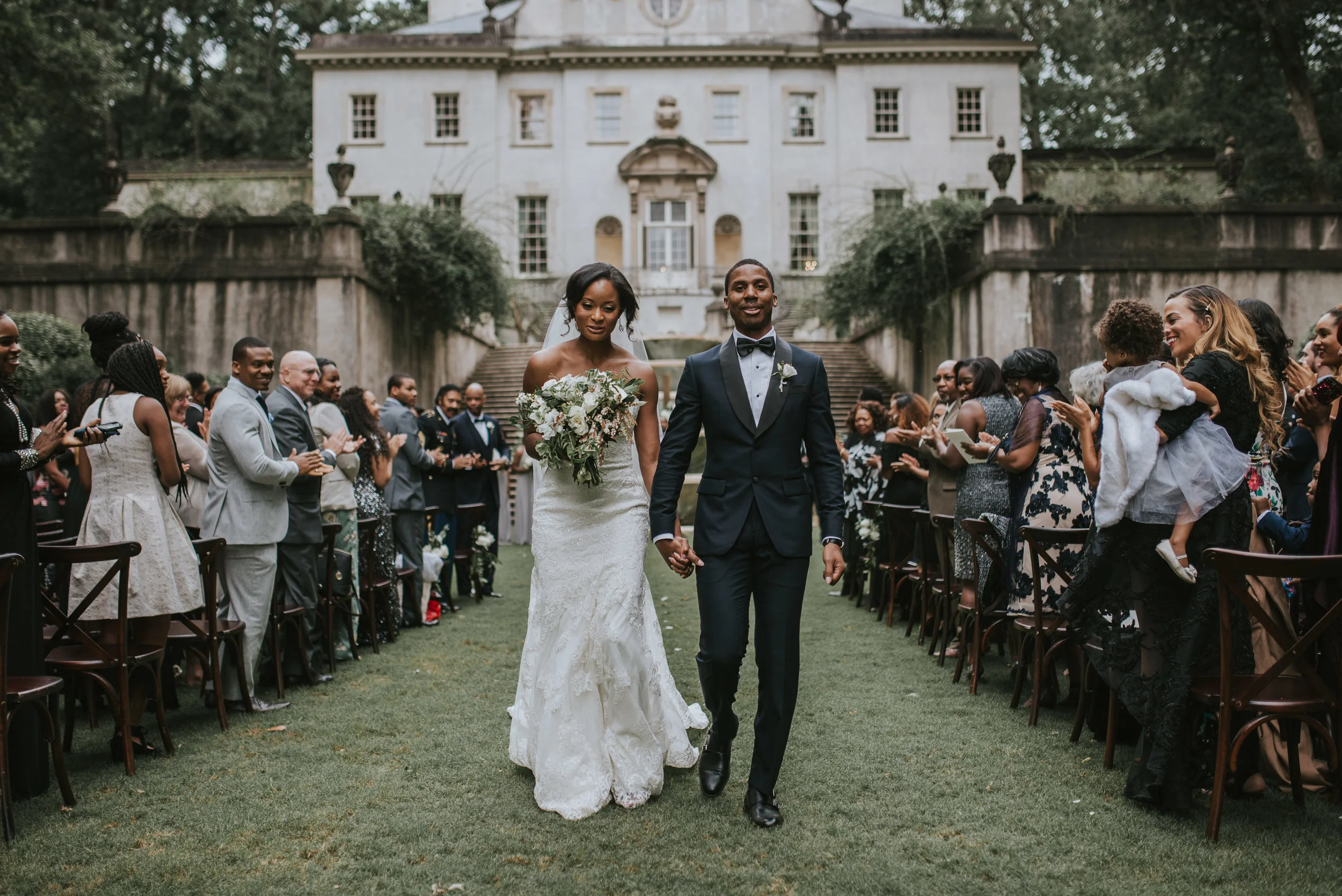 Bride and groom walk up aisle at Swan House in Atlanta, GA
