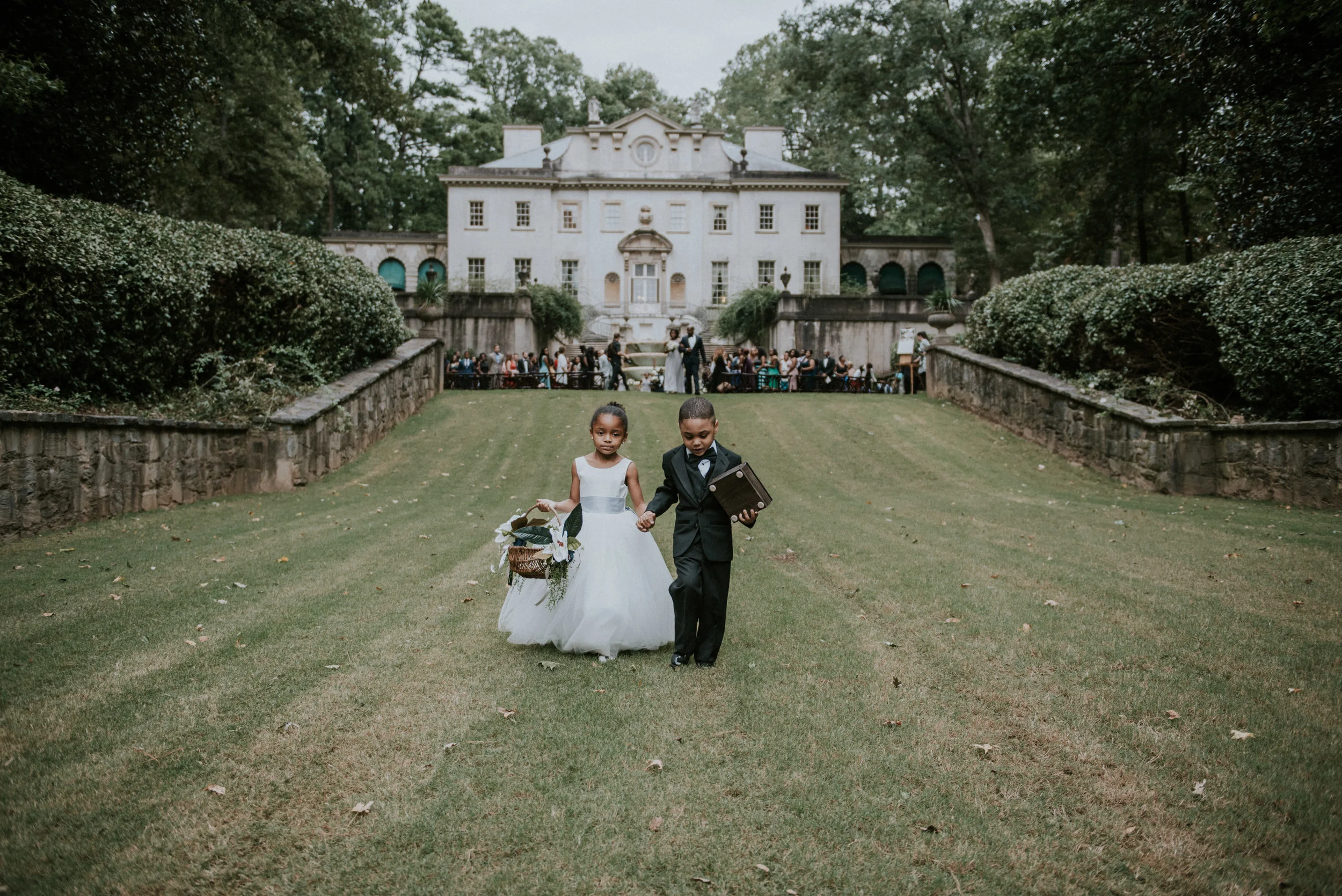 Flower girl and ring bearer with Swan House in the background in Atlanta, GA