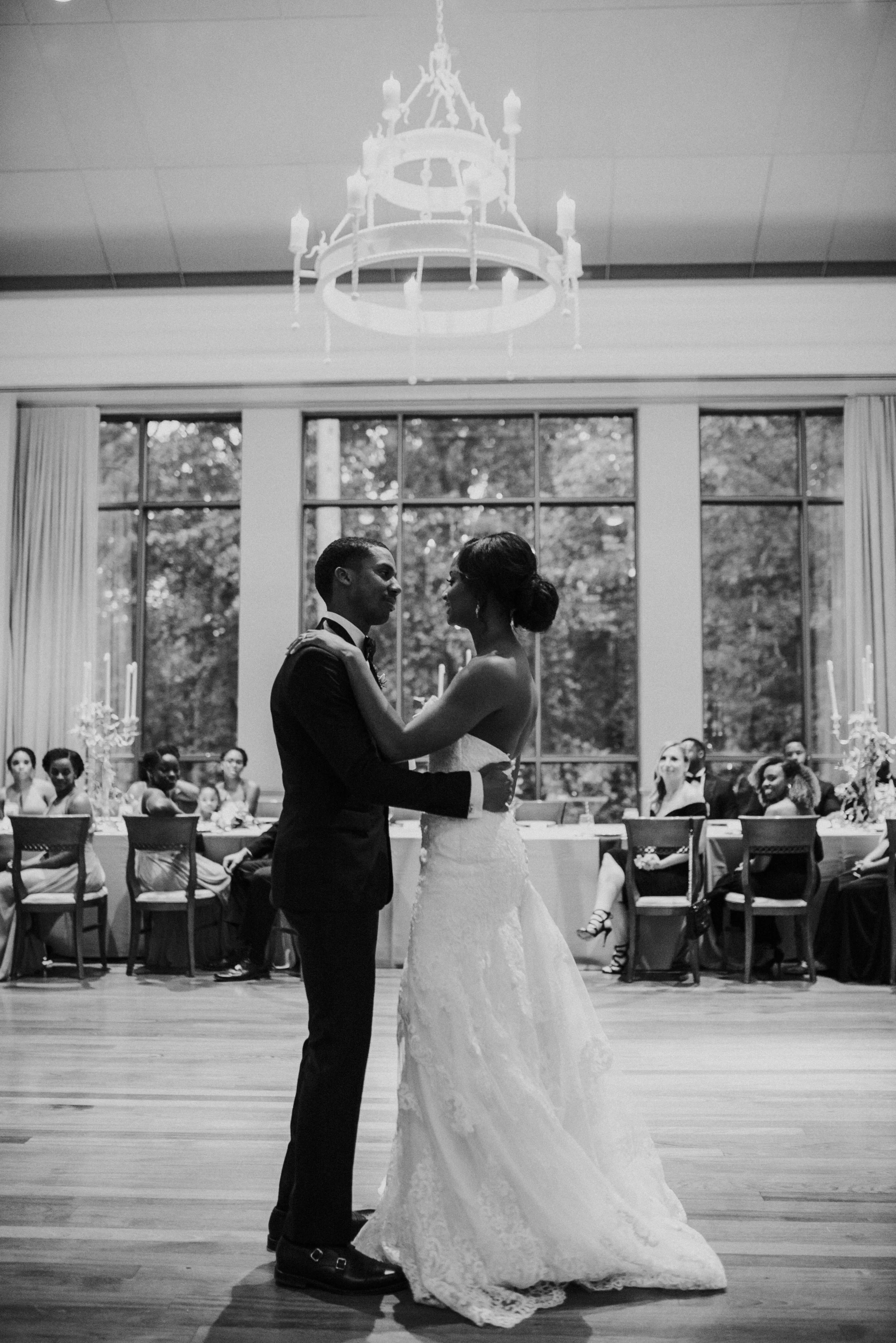 Bride and groom dance under chandelier at Atlanta History Center