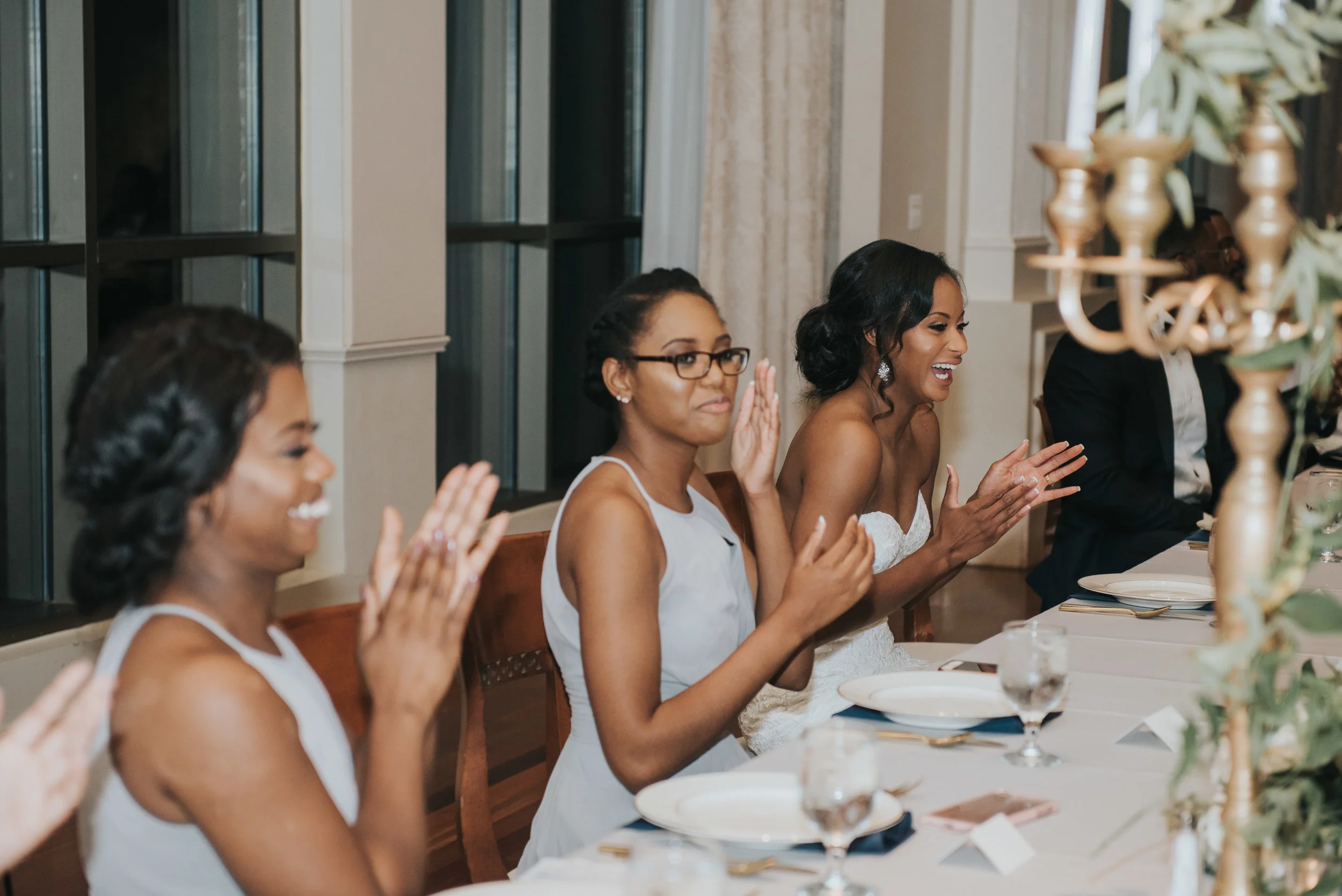 Bridesmaids clapping during wedding reception