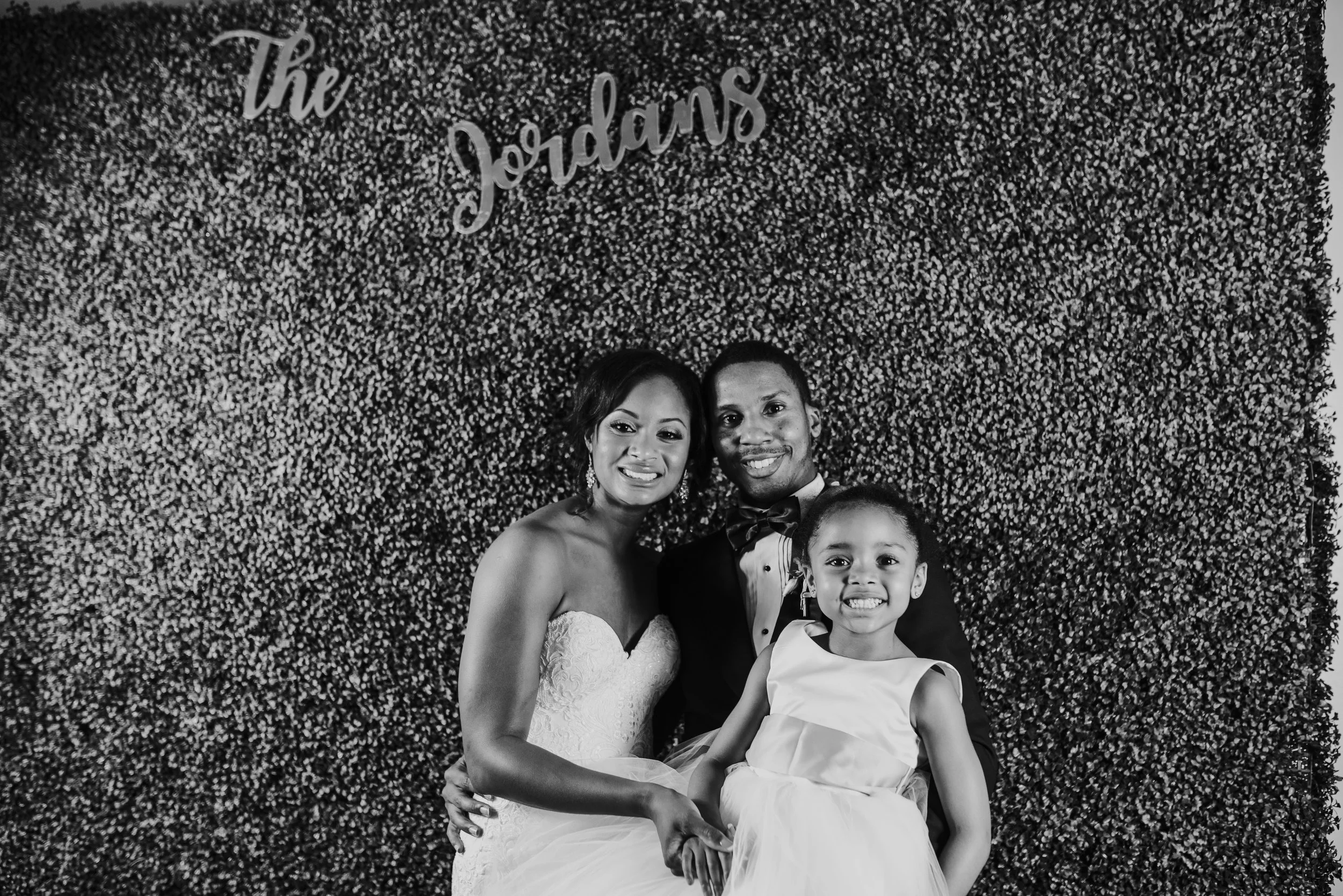 Family portrait of the bride, groom, and flower girl