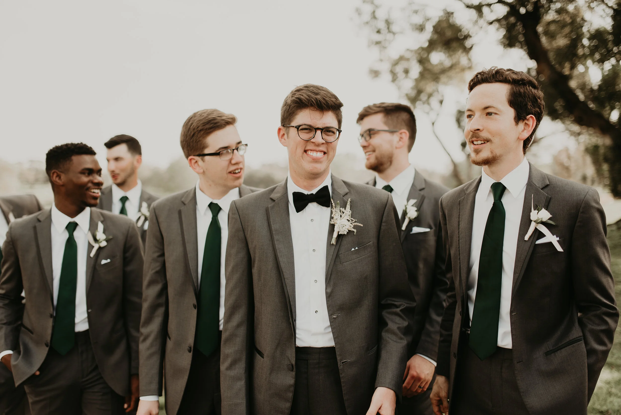 Groomsmen wearing gray Men's Wearhouse suits