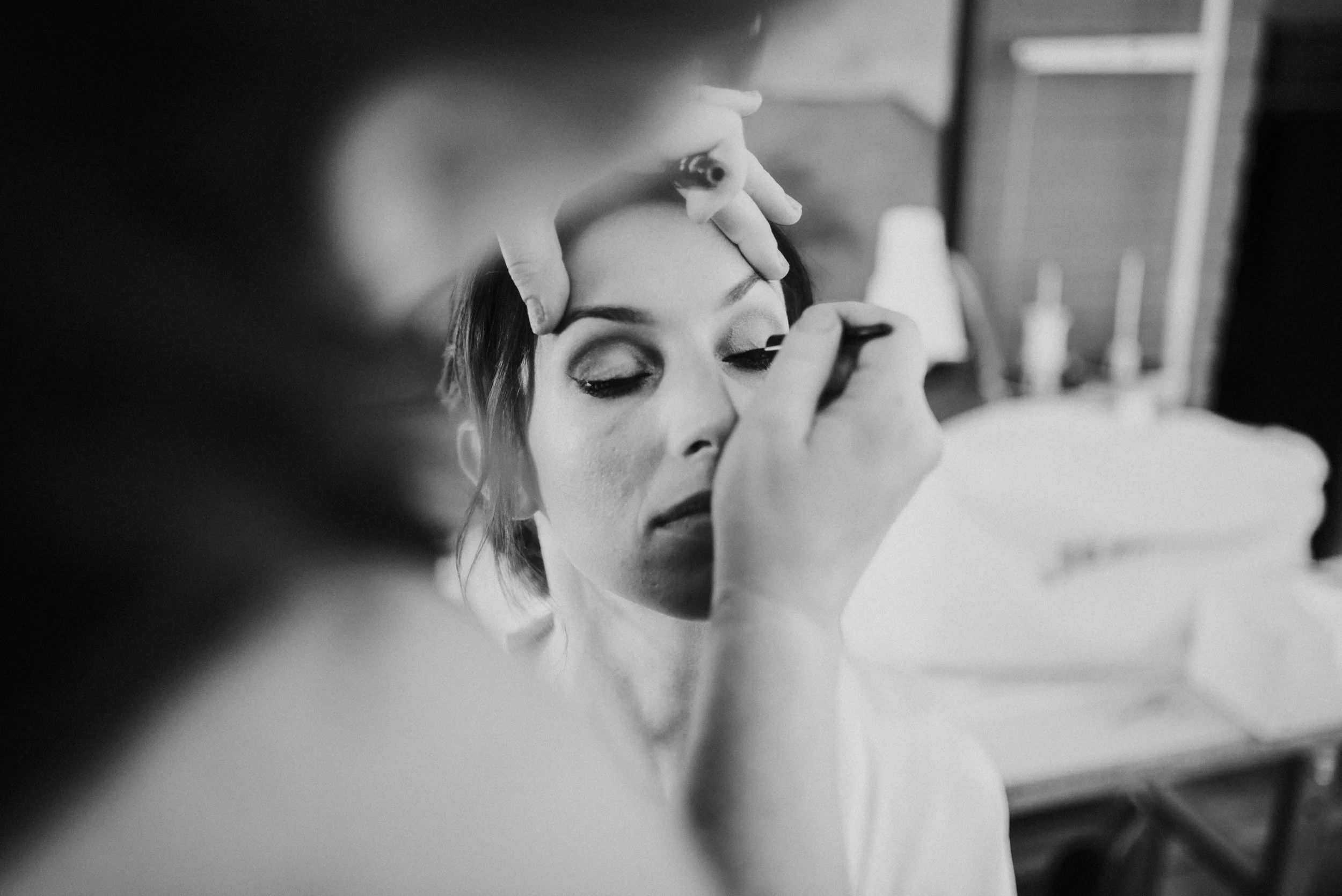 Bride having makeup work done