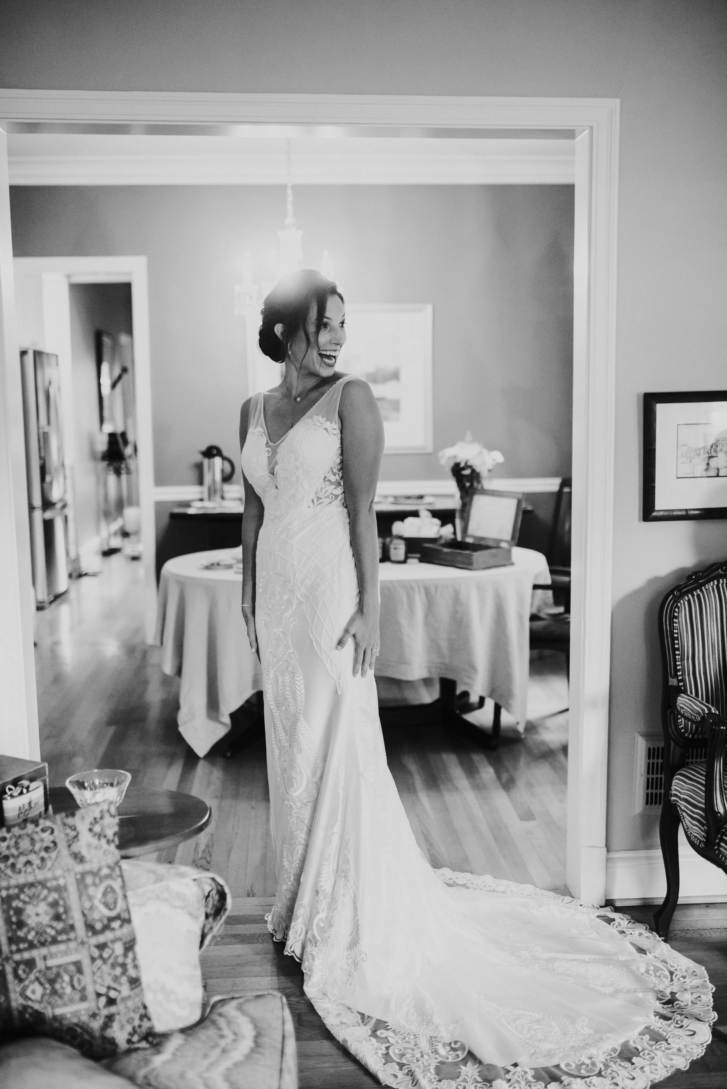 Bride first look with wedding dress in front of bridesmaids