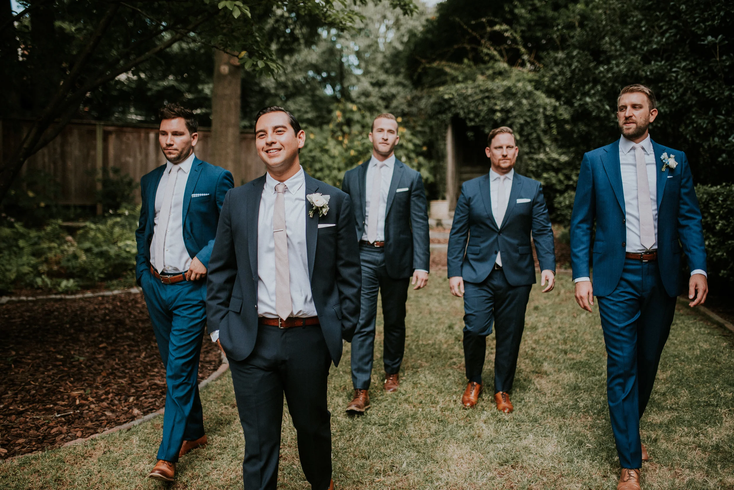 Groom and groomsmen in navy suits at The Trolley Barn