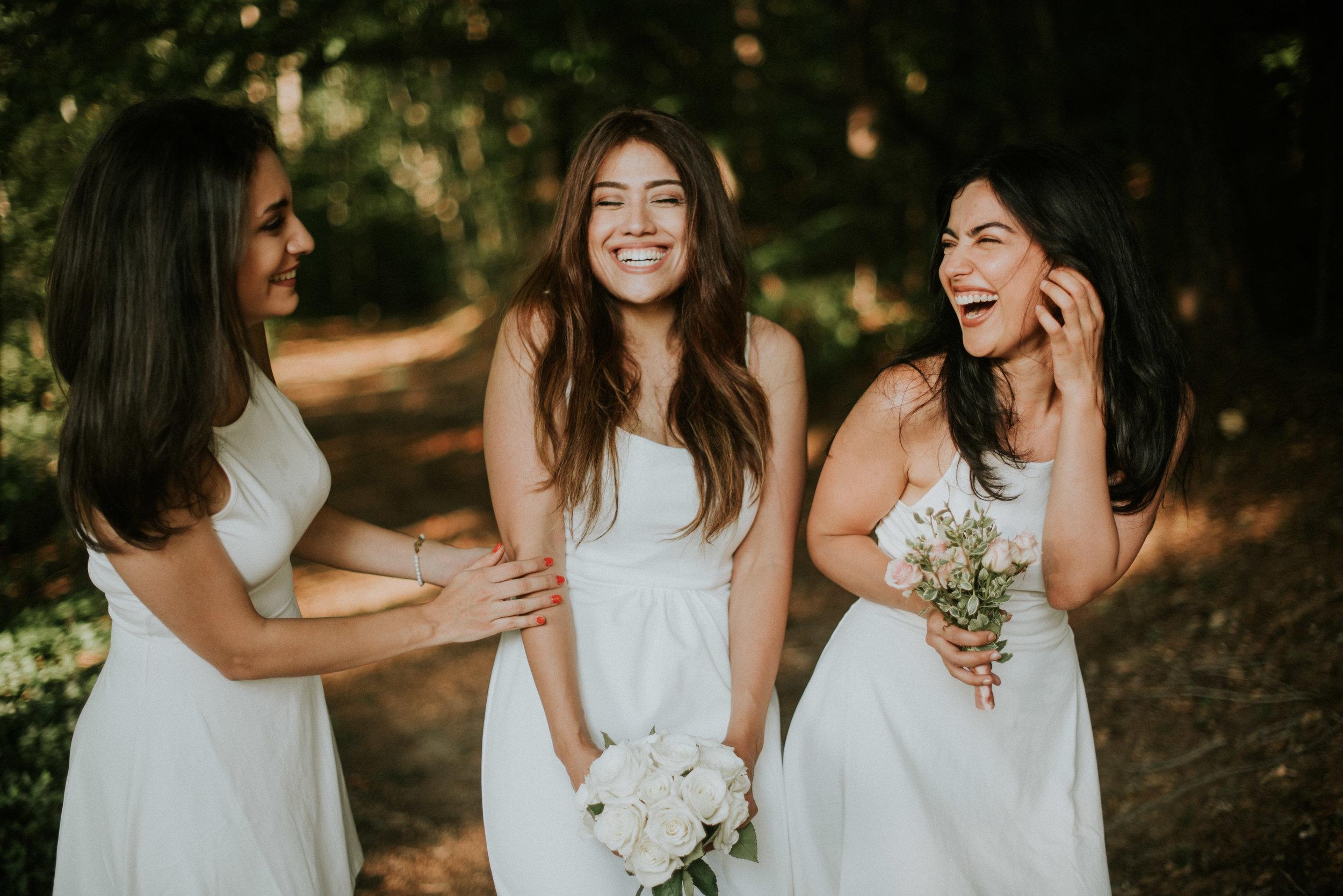 Bride and bridesmaids laughing at elopement