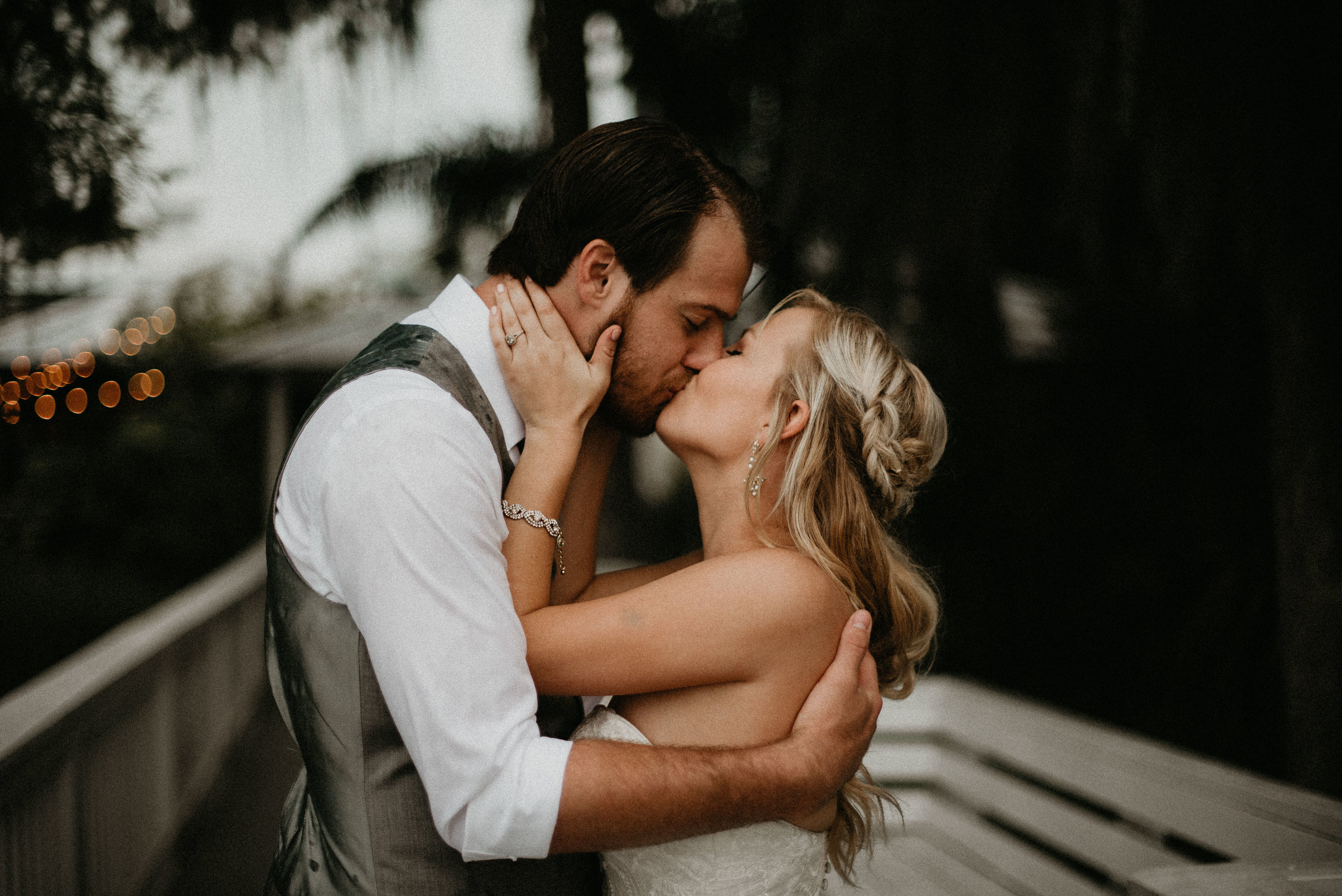 Bride and groom kissing at Paradise Cove dock in Orlando, FL