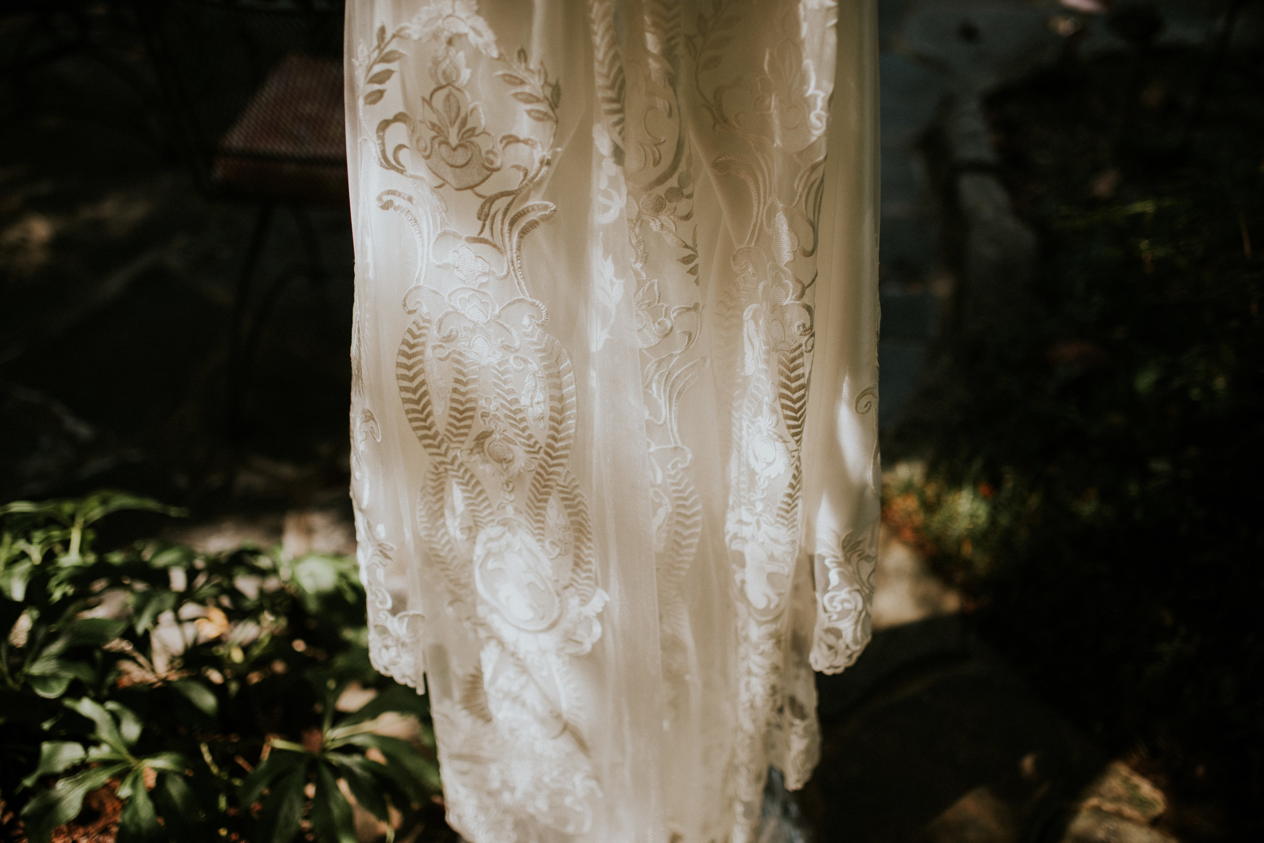 Wedding dress hanging with shadows