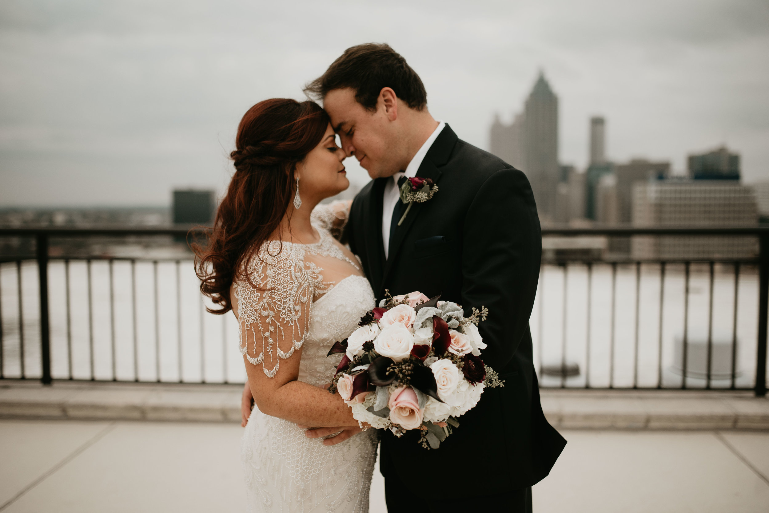 Bride and groom nose-to-nose at the Georgian Terrace roof in Atlanta, GA