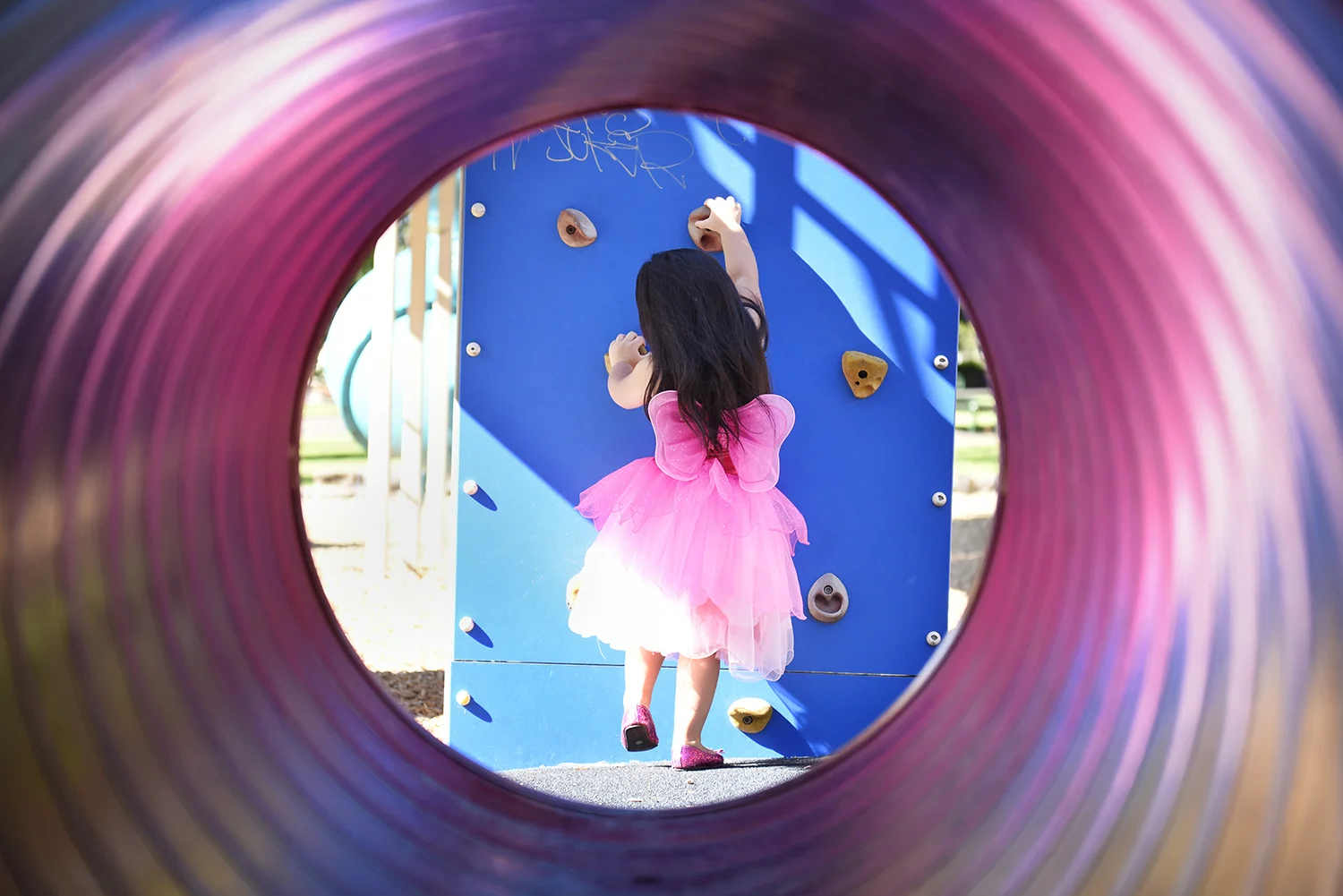  Little girl in the playground wearing a tutu. Photography by Kris Reichl 