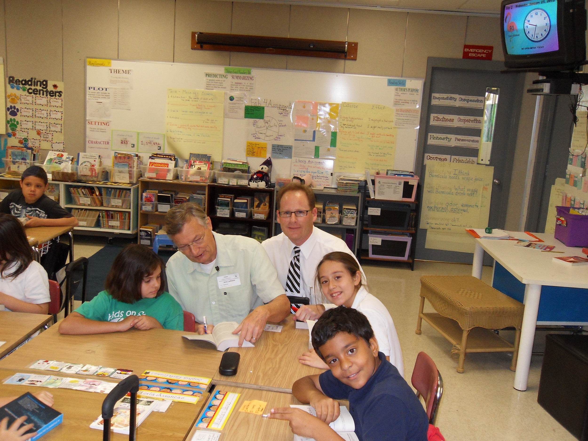Adam and fellow Rotarian giving out dictionaries to the 3rd grade classes at Calusa Elementary School.