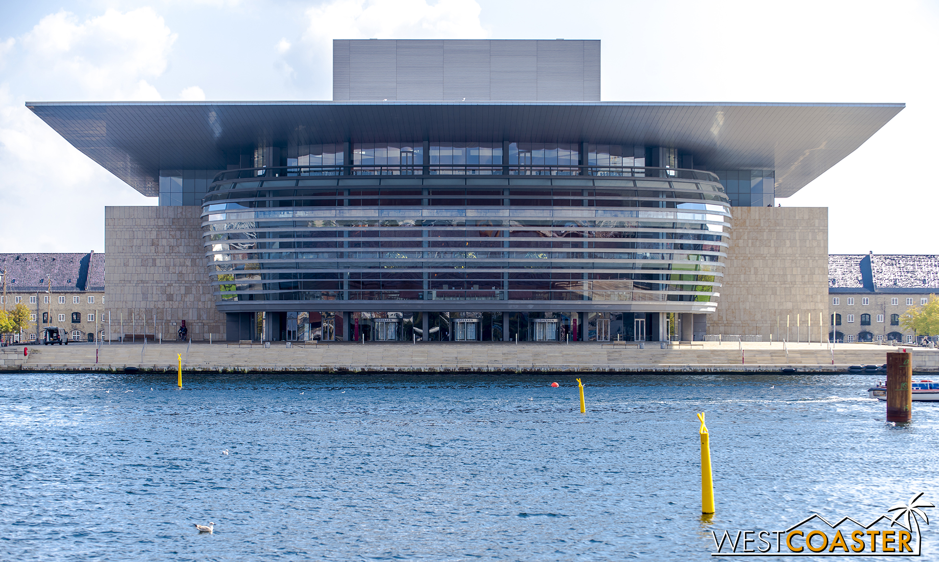 The sleek and stunning Opera House features an impossibly thin roof cantilevering in all directions forming a giant canopy over its plaza below.