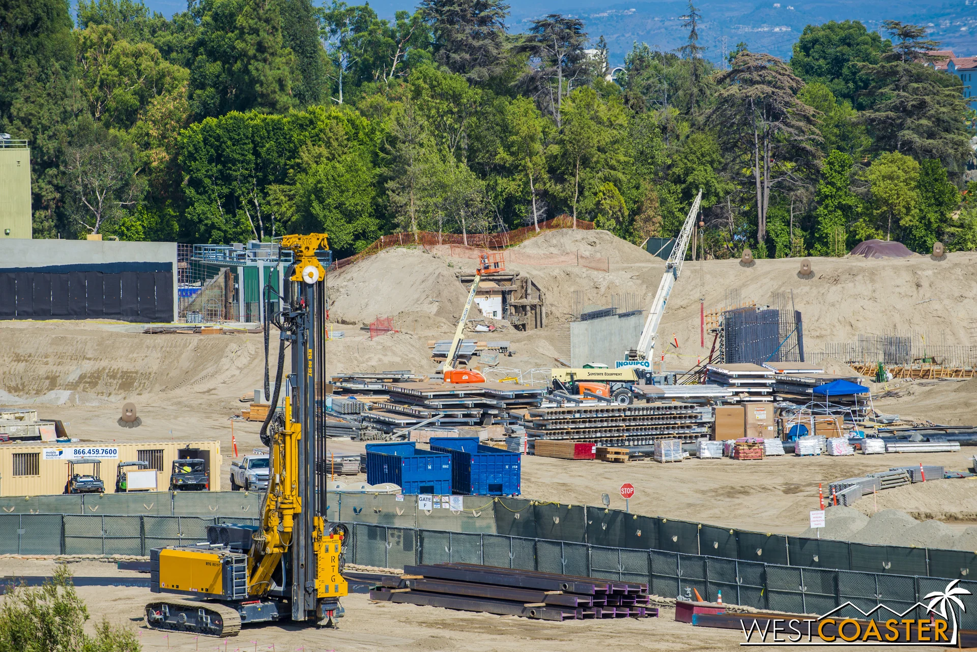 Meanwhile, more pre-constructed formwork lies by another set of concrete walls going up.