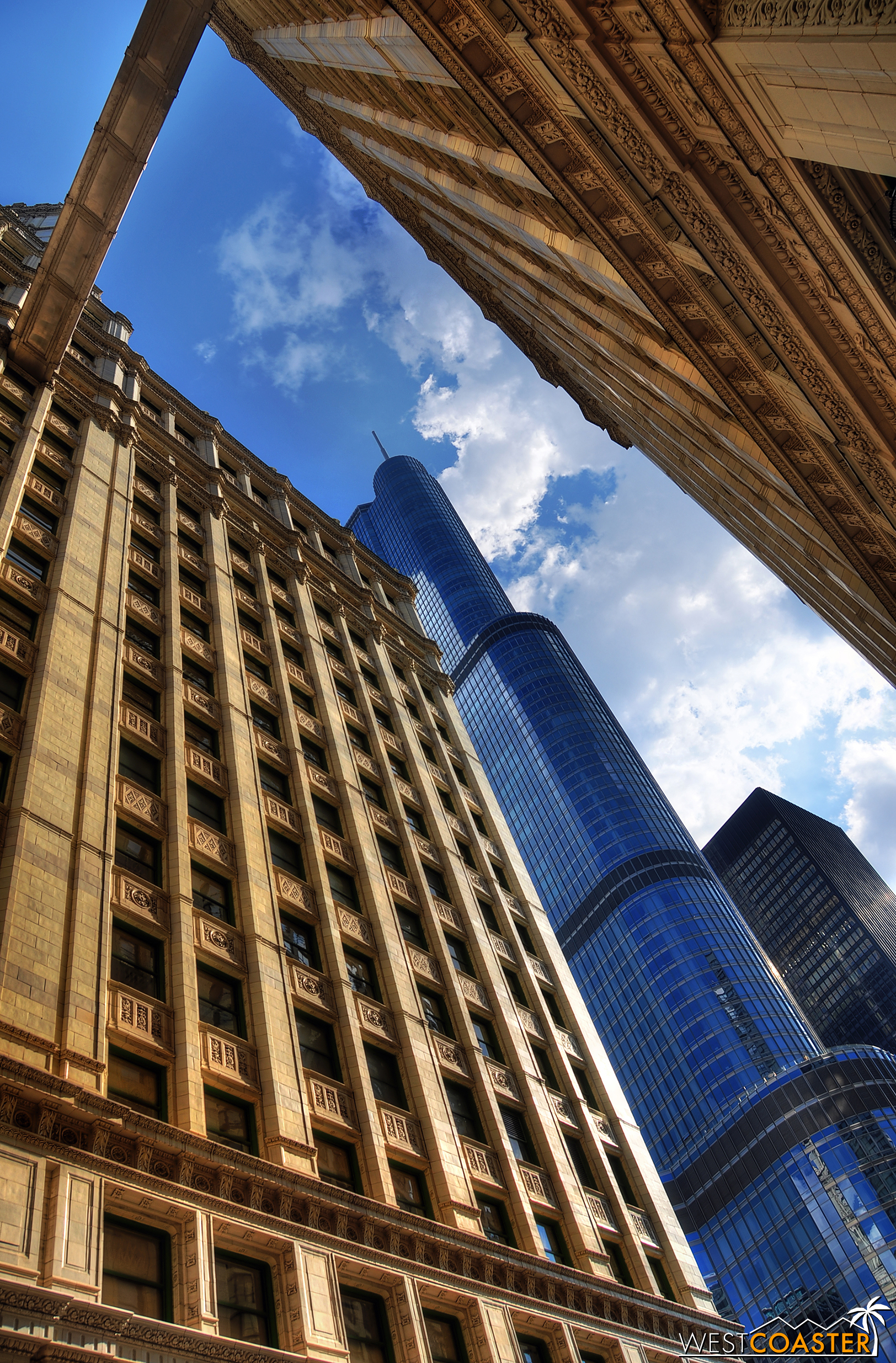 The sleek, glistening, and flashy Trump Tower looms behind the view created by the classic Wrigley Building.