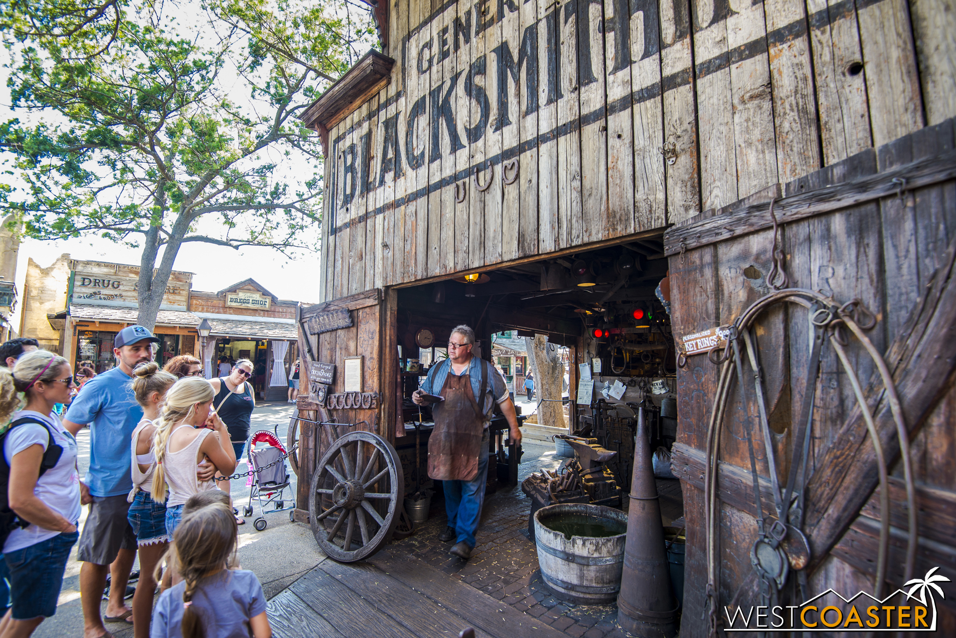  A crowd gathers around to see the town blacksmith at work. 