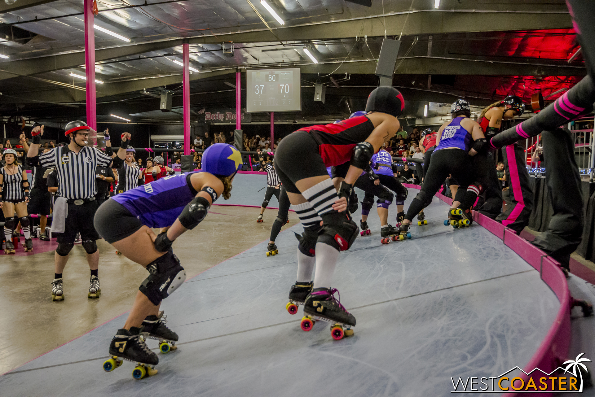 The jammers at the ready position, prepared to skate forth seconds after the blockers begin.