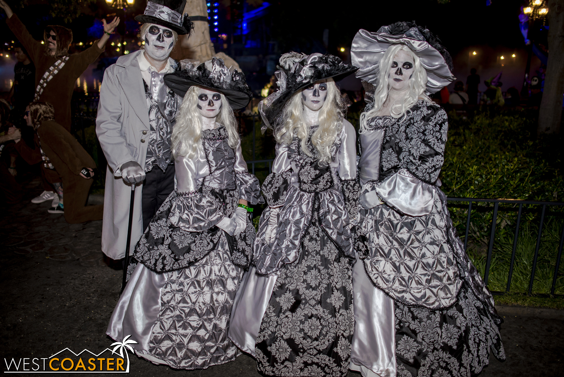 A ghostly Haunted Mansion family poses for photos at Mickey's Halloween Party.