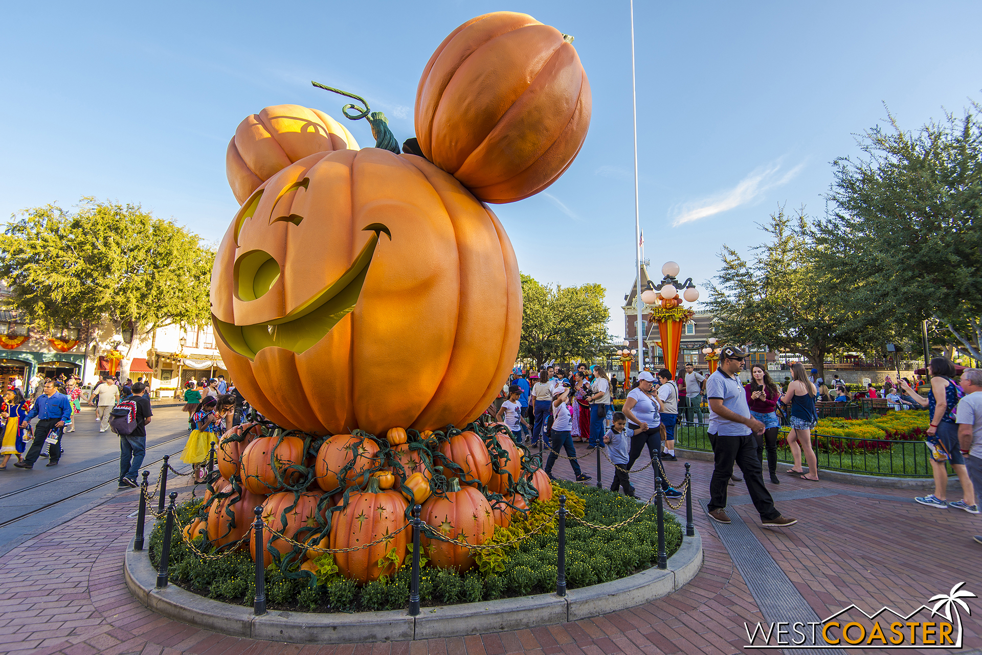  Early on, Halloween Party guests line up to get their photos taken in front of the big Mickey Pumpkin. 