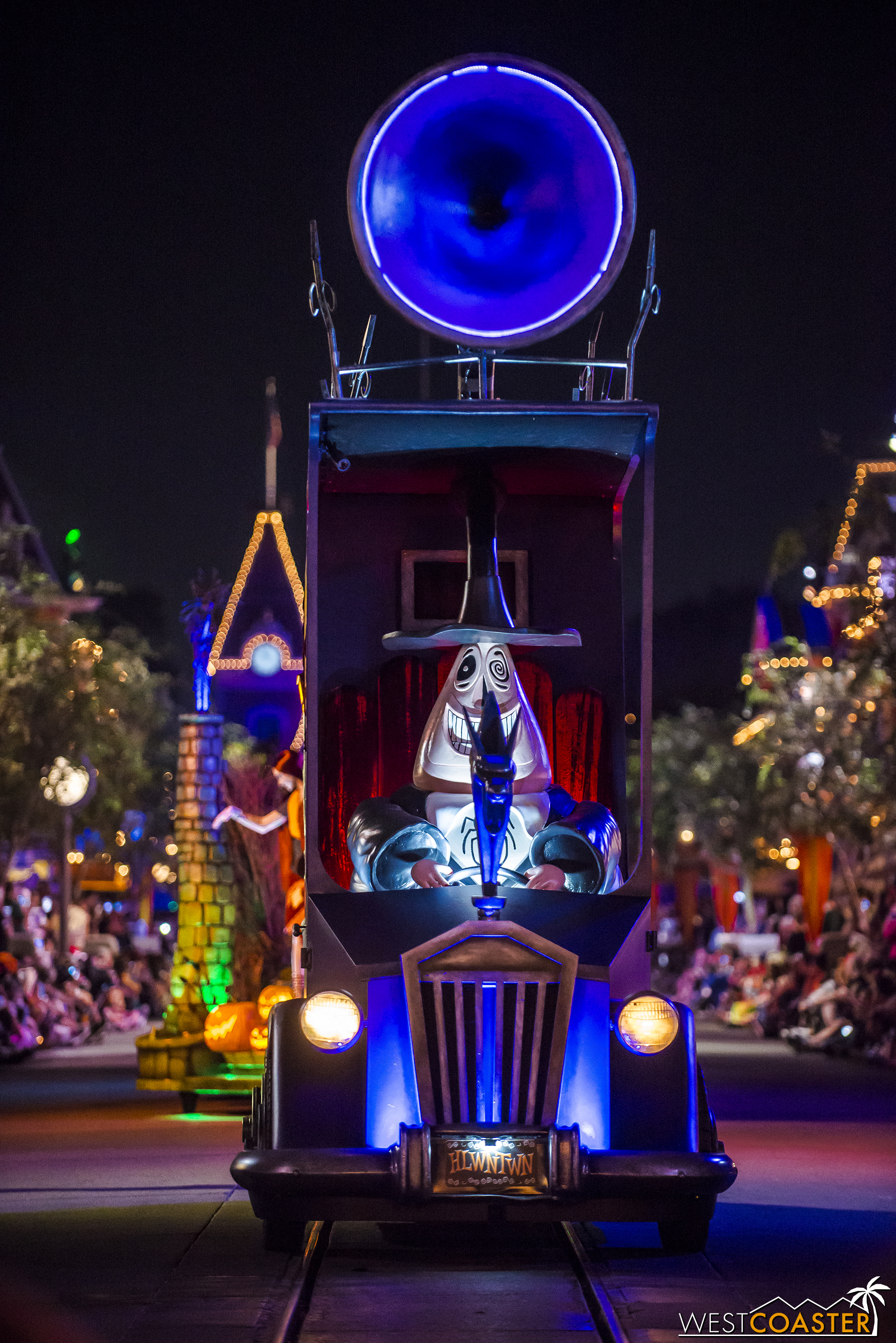  The Mayor of Halloween Town drives his vehicle up Main Street. 