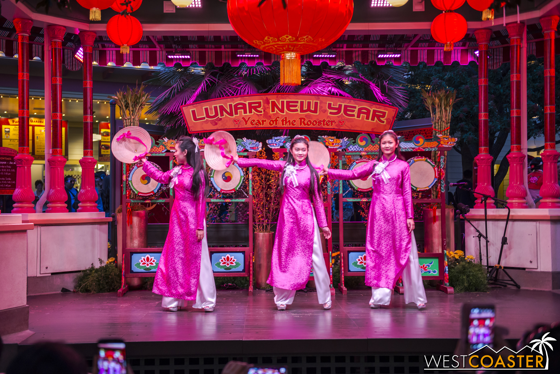 Three young ladies perform a Vietnamese hat dance.
