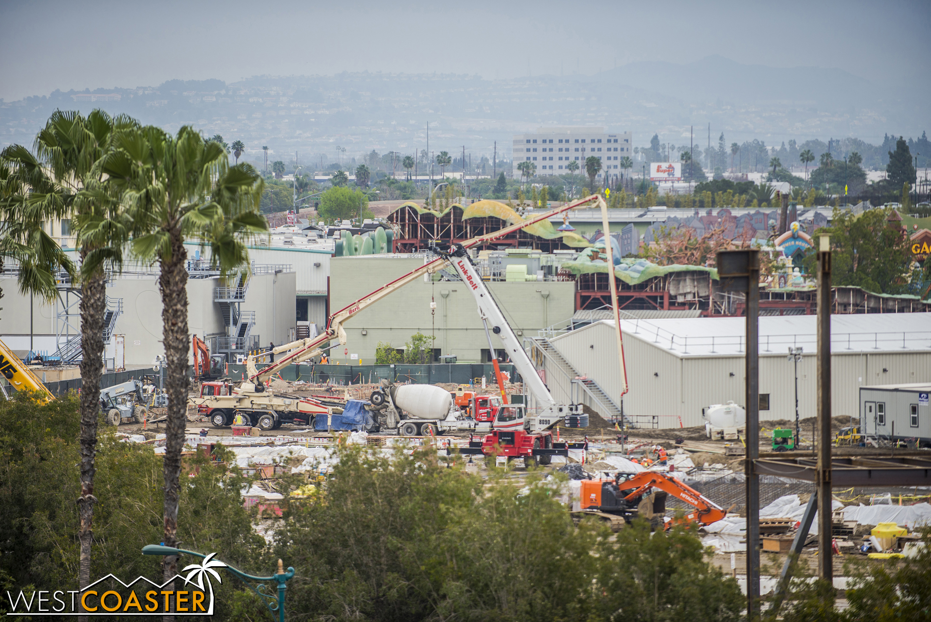  Over in the back corner, near Mickey's Toontown, concrete trucks appear to be pouring concrete for another building. 