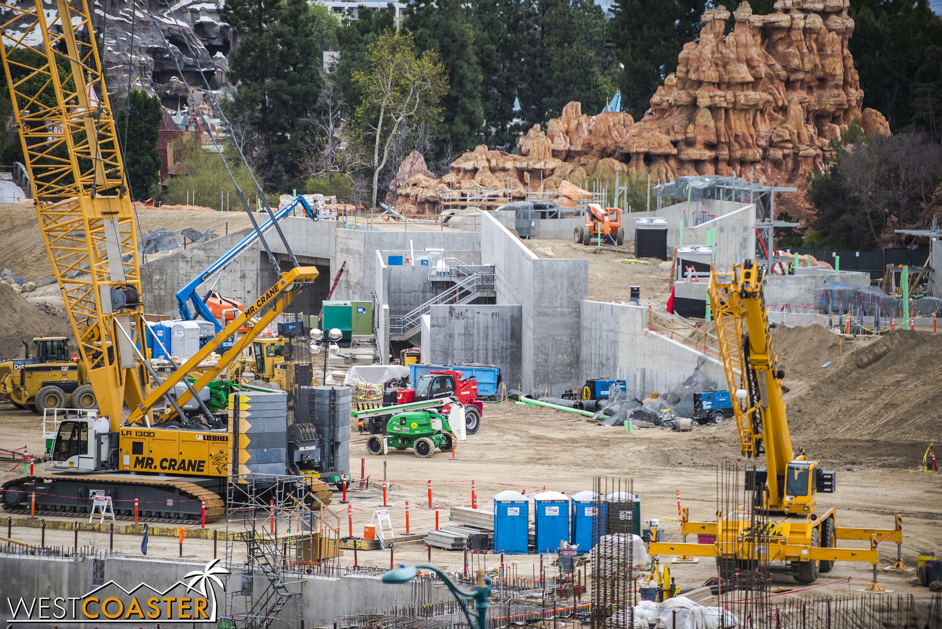  Some stairs have sprung up along the concrete retaining walls supporting the berm and service drive over the future "Star Wars" Land main entrance section. 