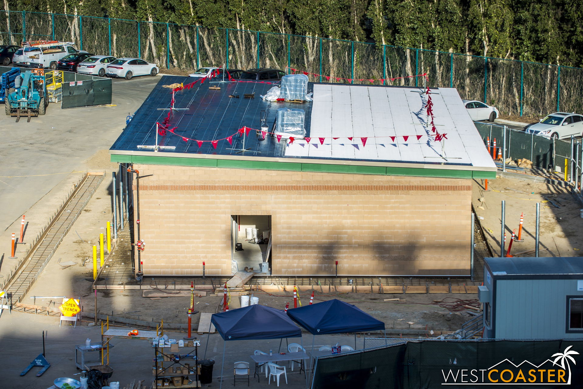 The roof decking is complete on this transportation building, and now they're starting to apply the actual roofing membrane.