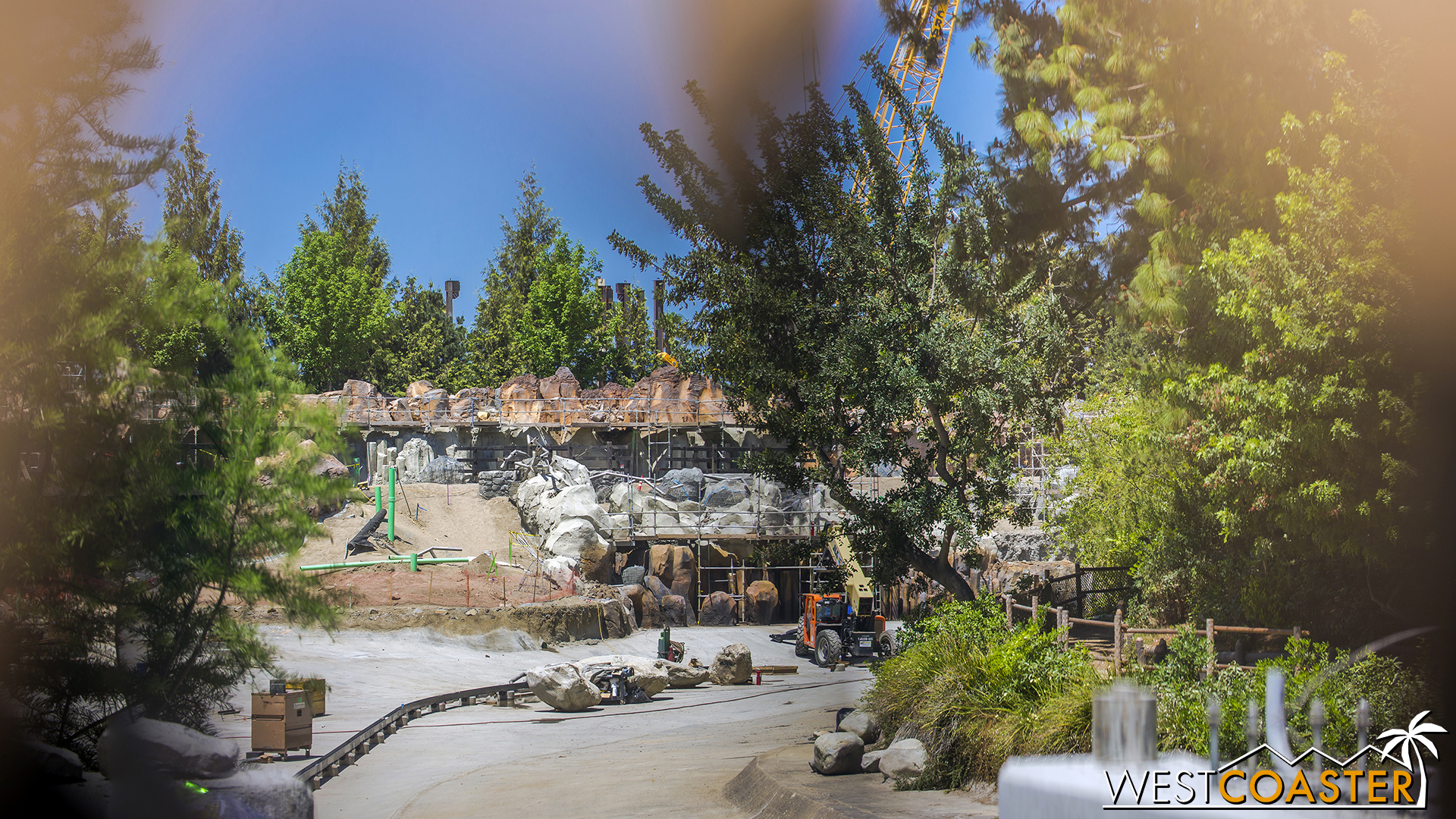  There's a little opening in the construction walls with the negative of a knot in a wood plank, and that gives people a peek into the happenings of the River. 