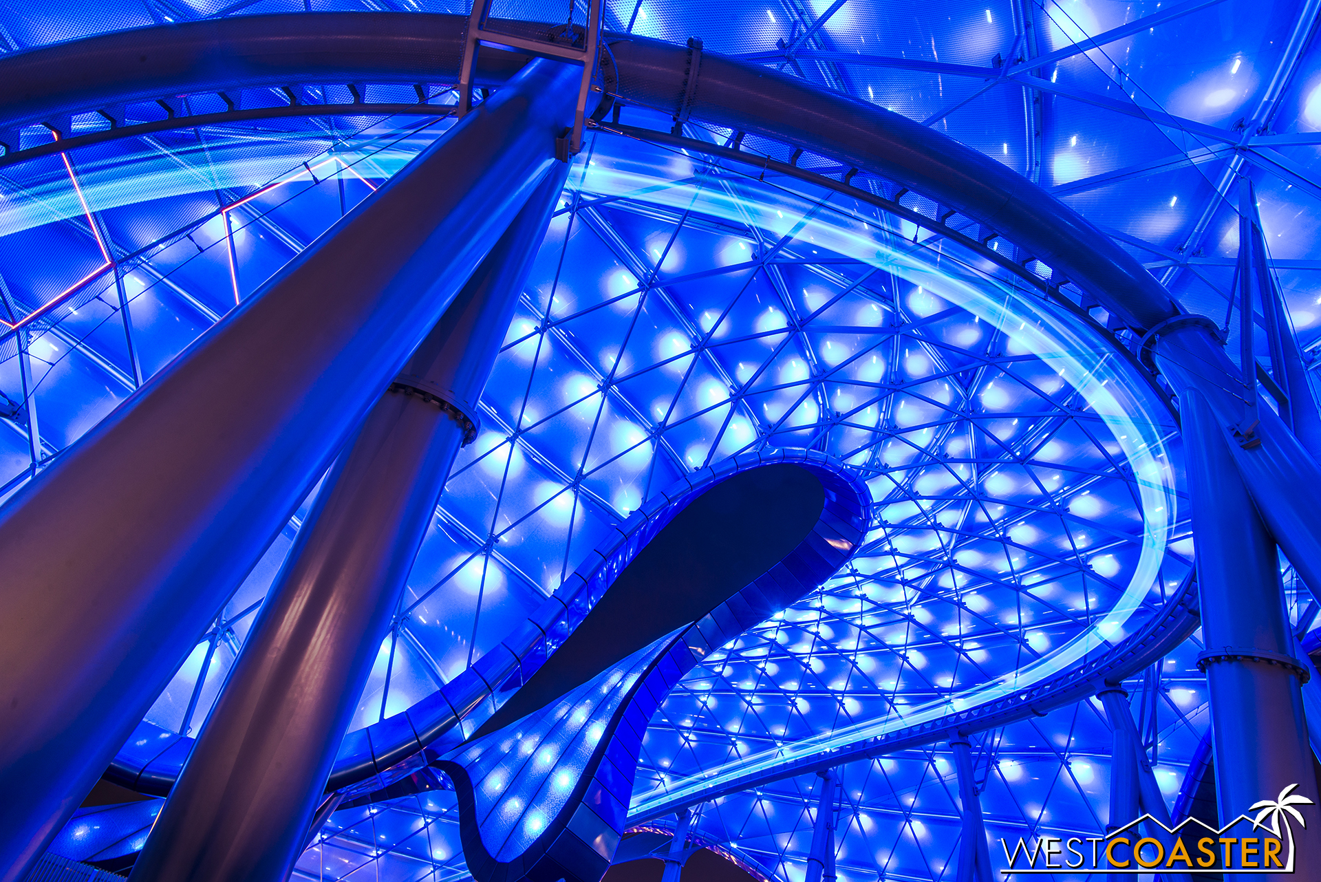 A lightcycle streaks around a turn in Tomorrowland.