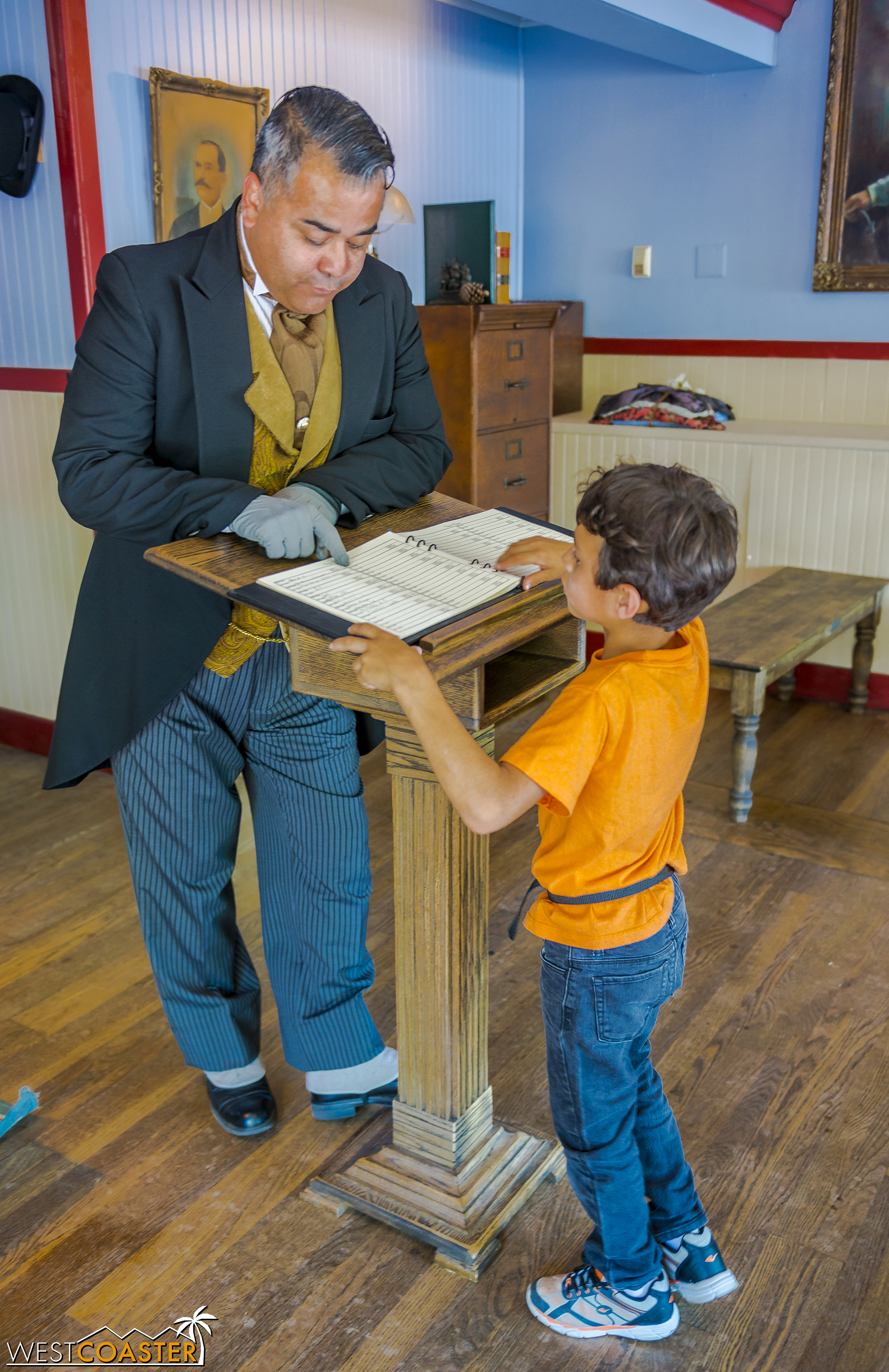  A young guest signs the Calico visitor's guest book with Mayor Parnell's guidance. 