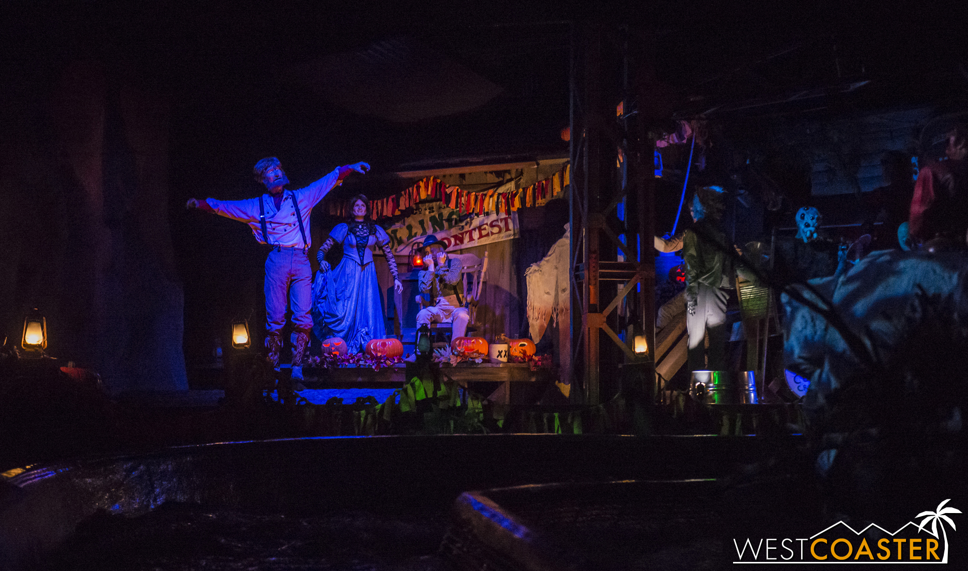  Inside, a group of folks celebrate the Halloween holiday. 