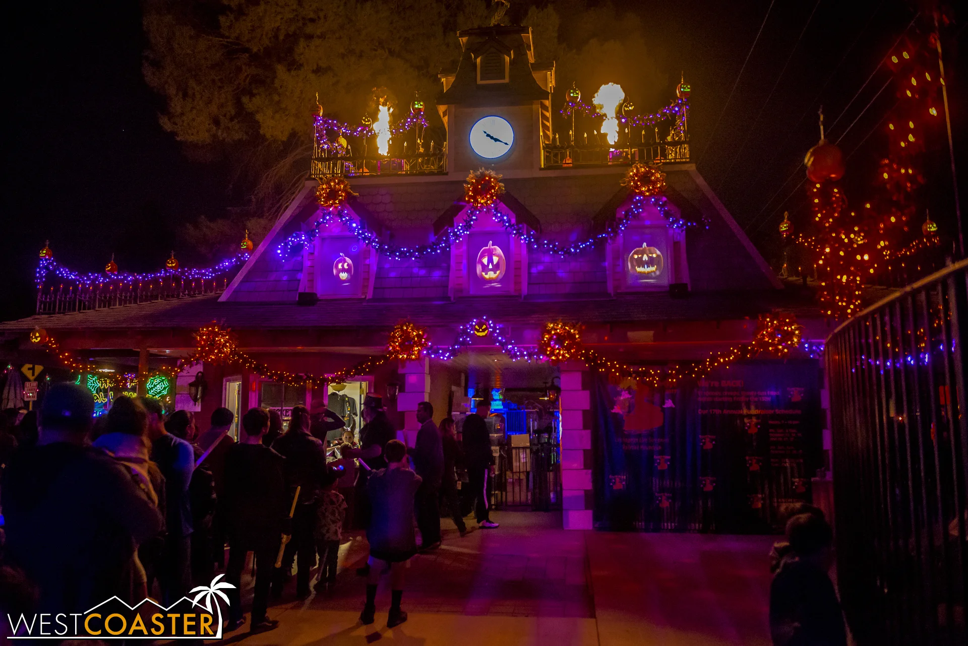 Guests gather at the dramatic, flame-lit entrance of the Ghost Train.