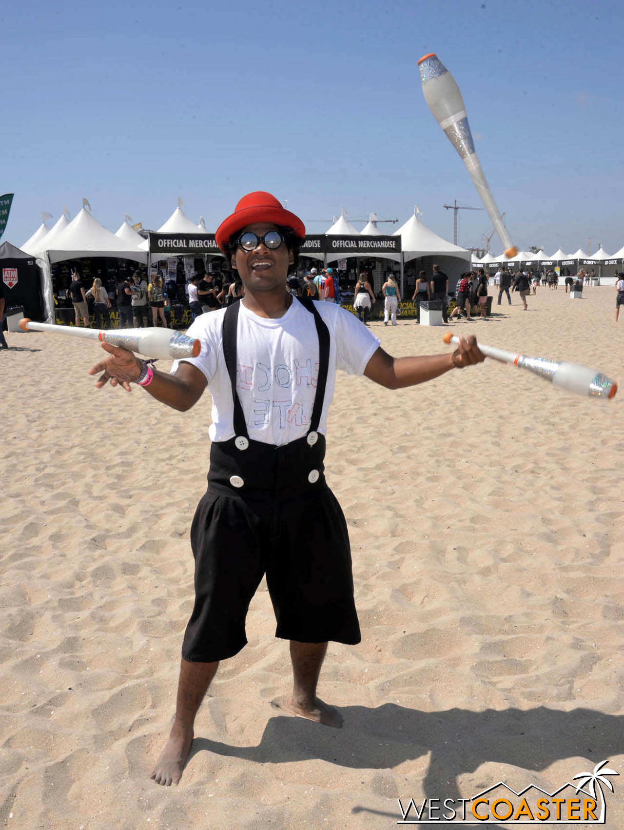  A juggler on hand on the sand. 