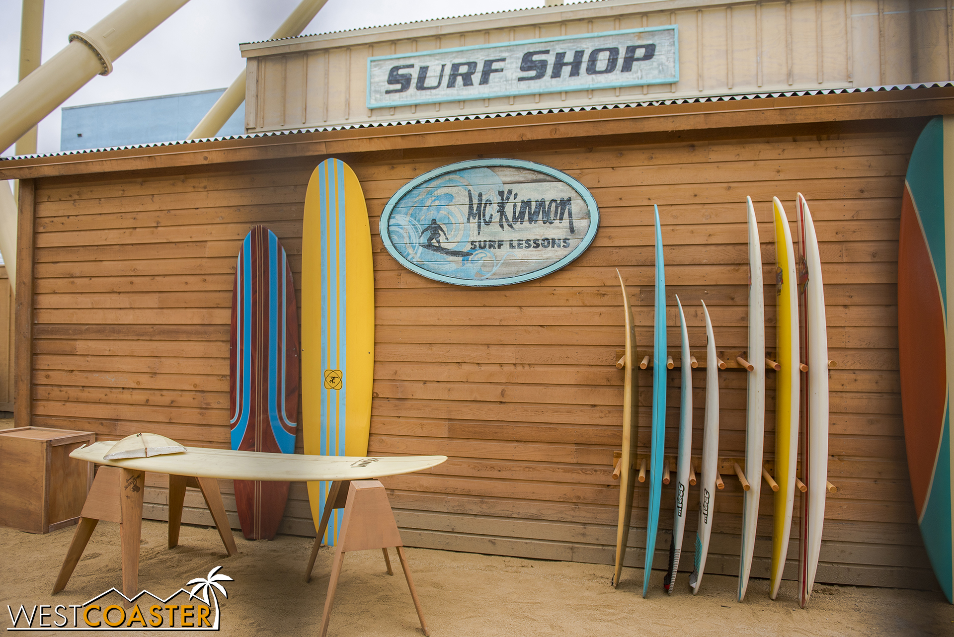  Lets look at the theming.  There’s a “surf shop” behind fencing, visible from the line. 