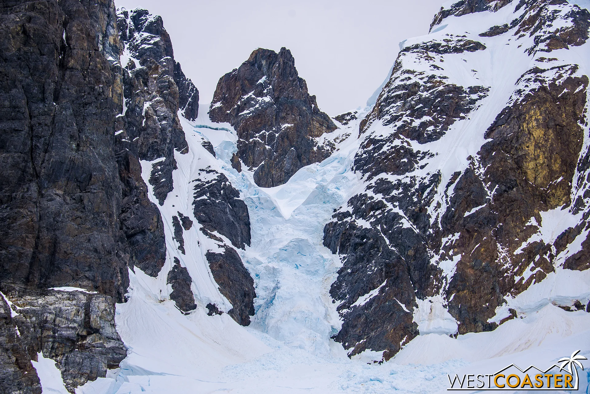 The tips of the mighty ranges surrounding the Lemaire are laden with snow and ice.