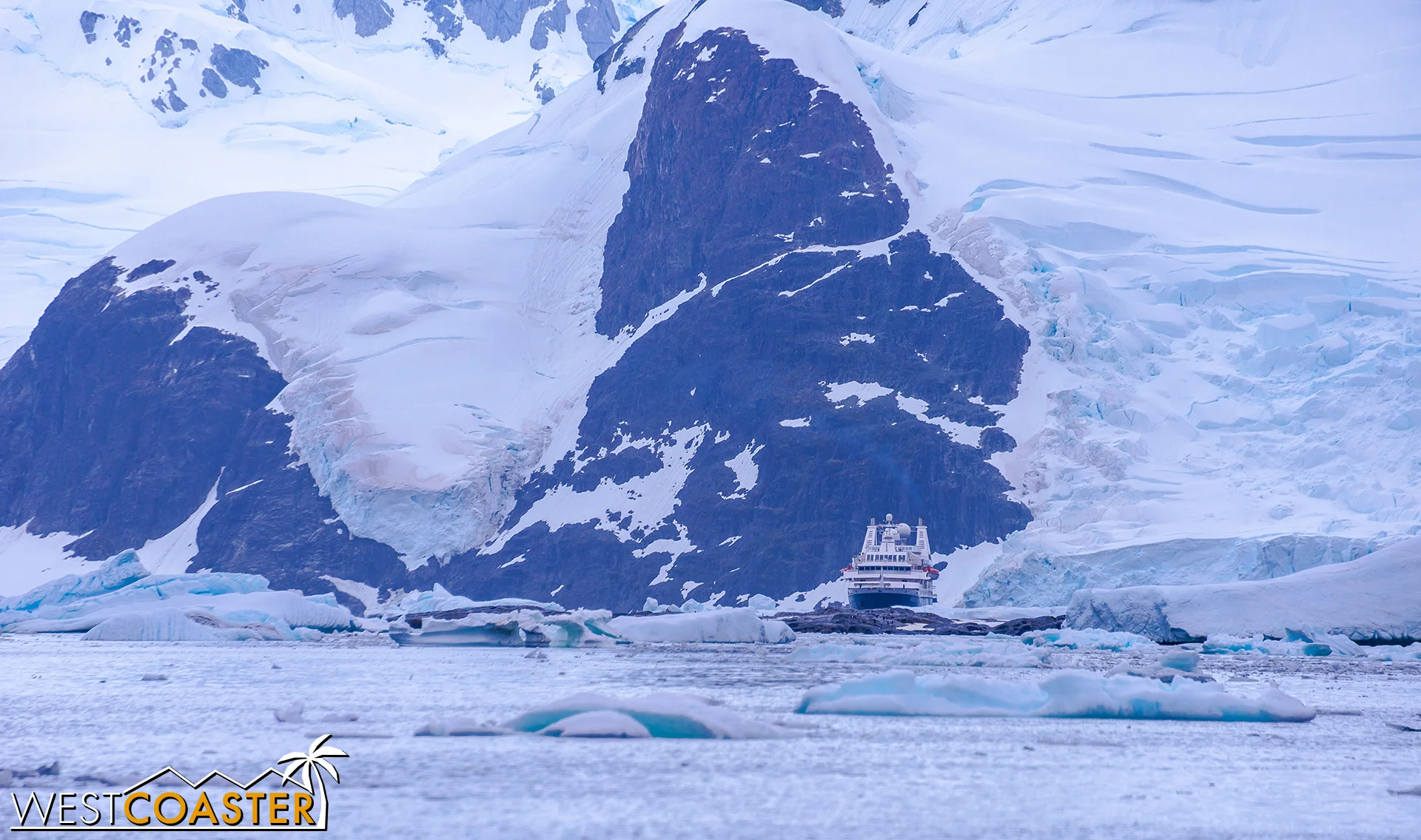 Adjacent mountains dwarf our Ocean Diamond cruise ship.