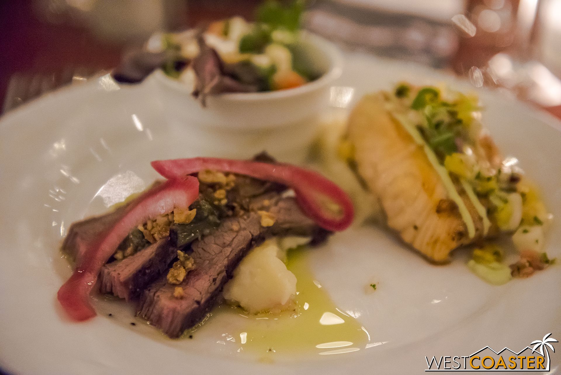  Flank steak with salmon fillet and strawberry and spinach salad. 