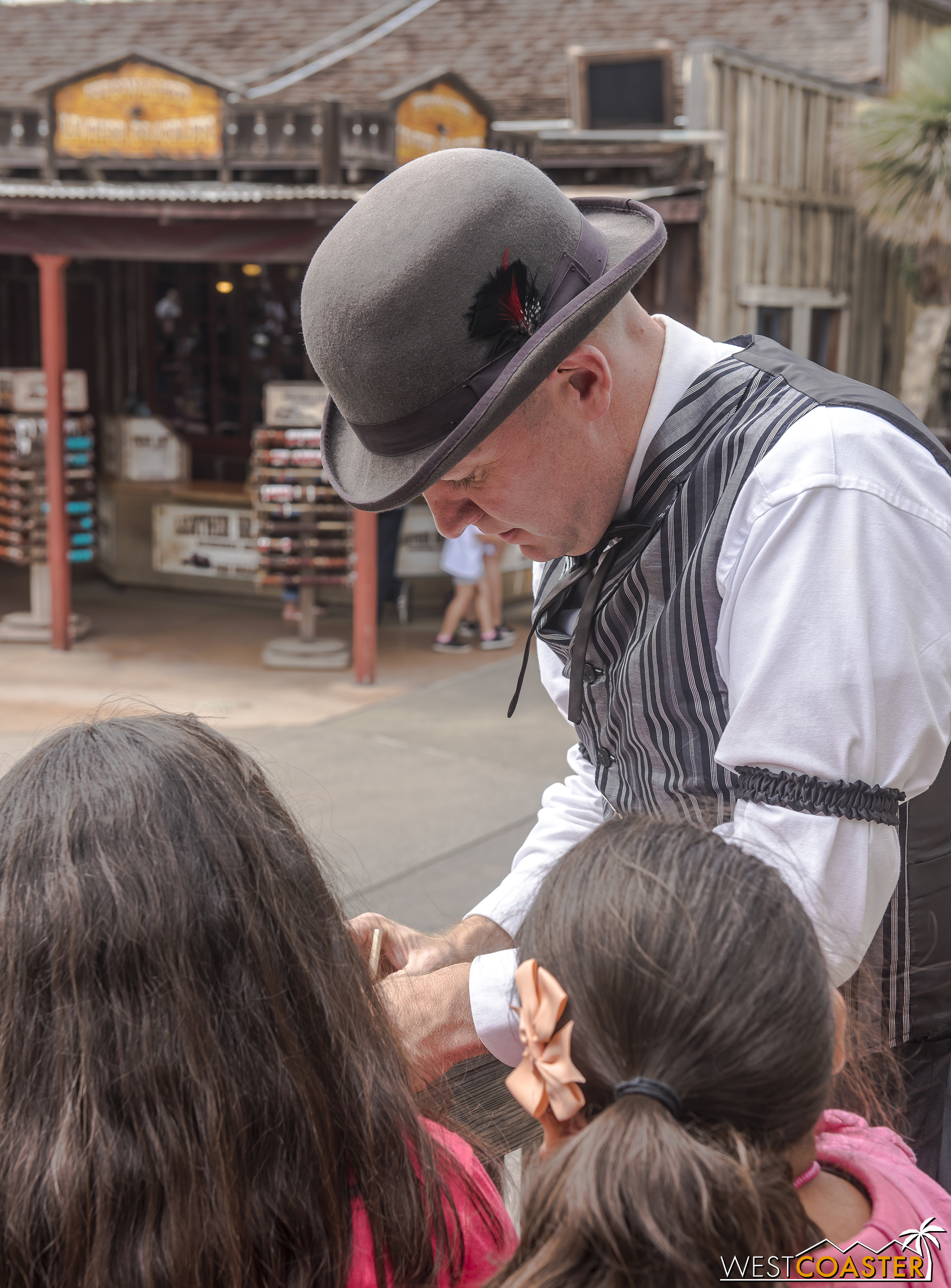  Colonel Potter engages with two young guests, asking them to help with a task. 