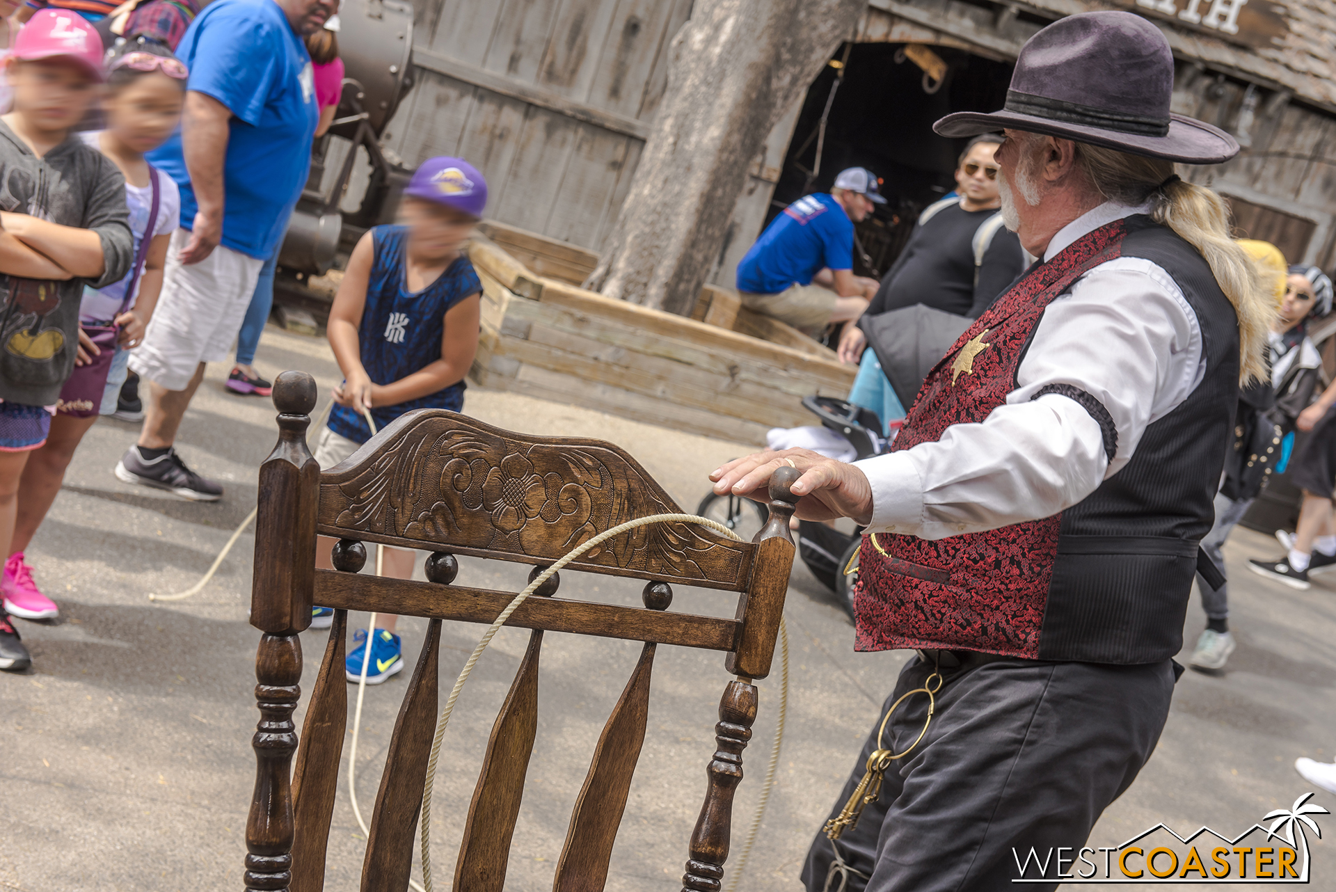  A child practices the fine art of rocking chair lasso’ing, with the encouragement and coaching of Sheriff Wheeler. 