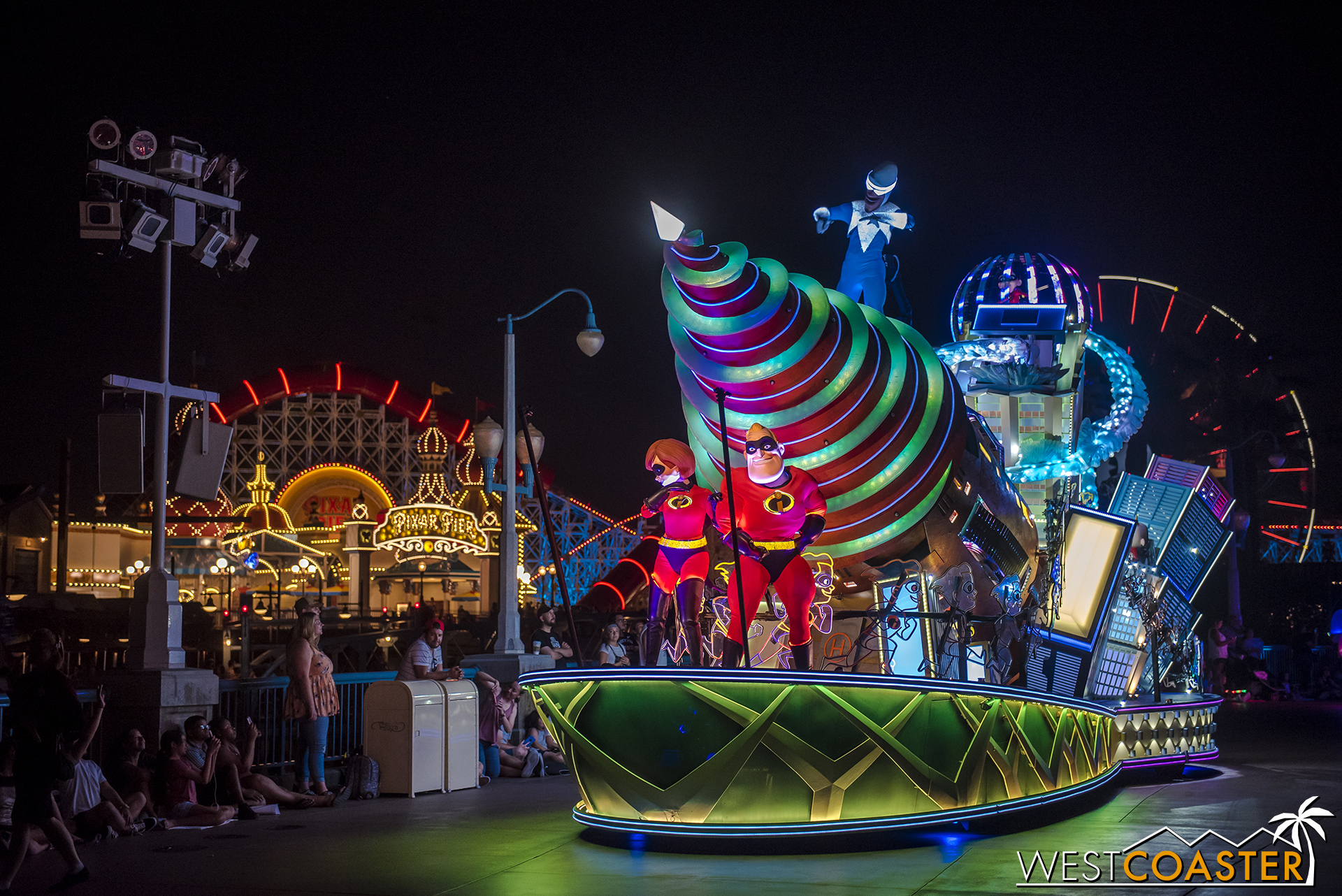  Mr. and Mrs. Incredible pose in front of an elaborate float. 