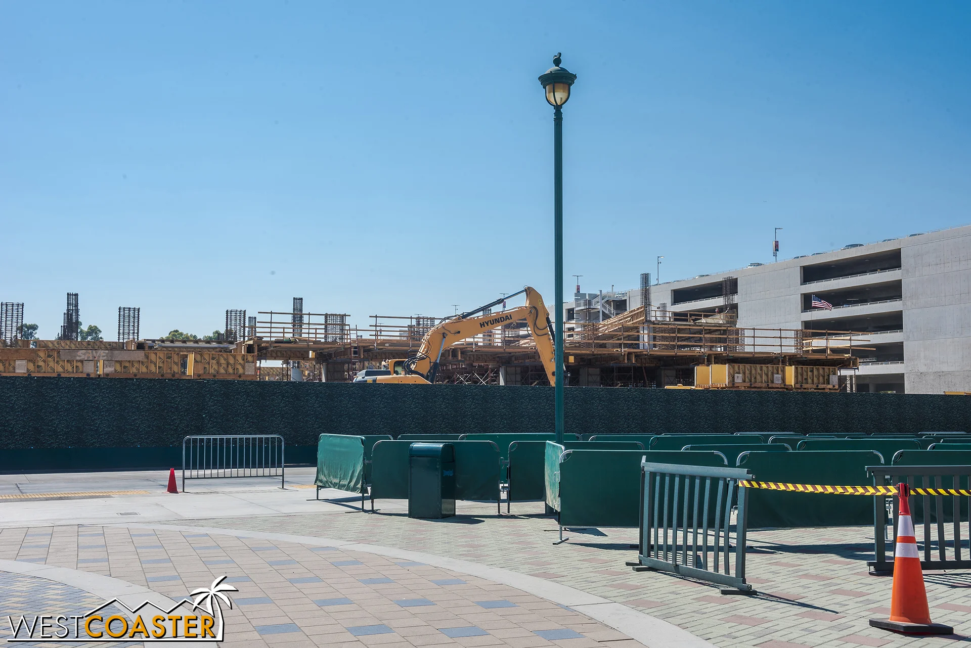 From ground level, the structure is rising above the construction fencing.